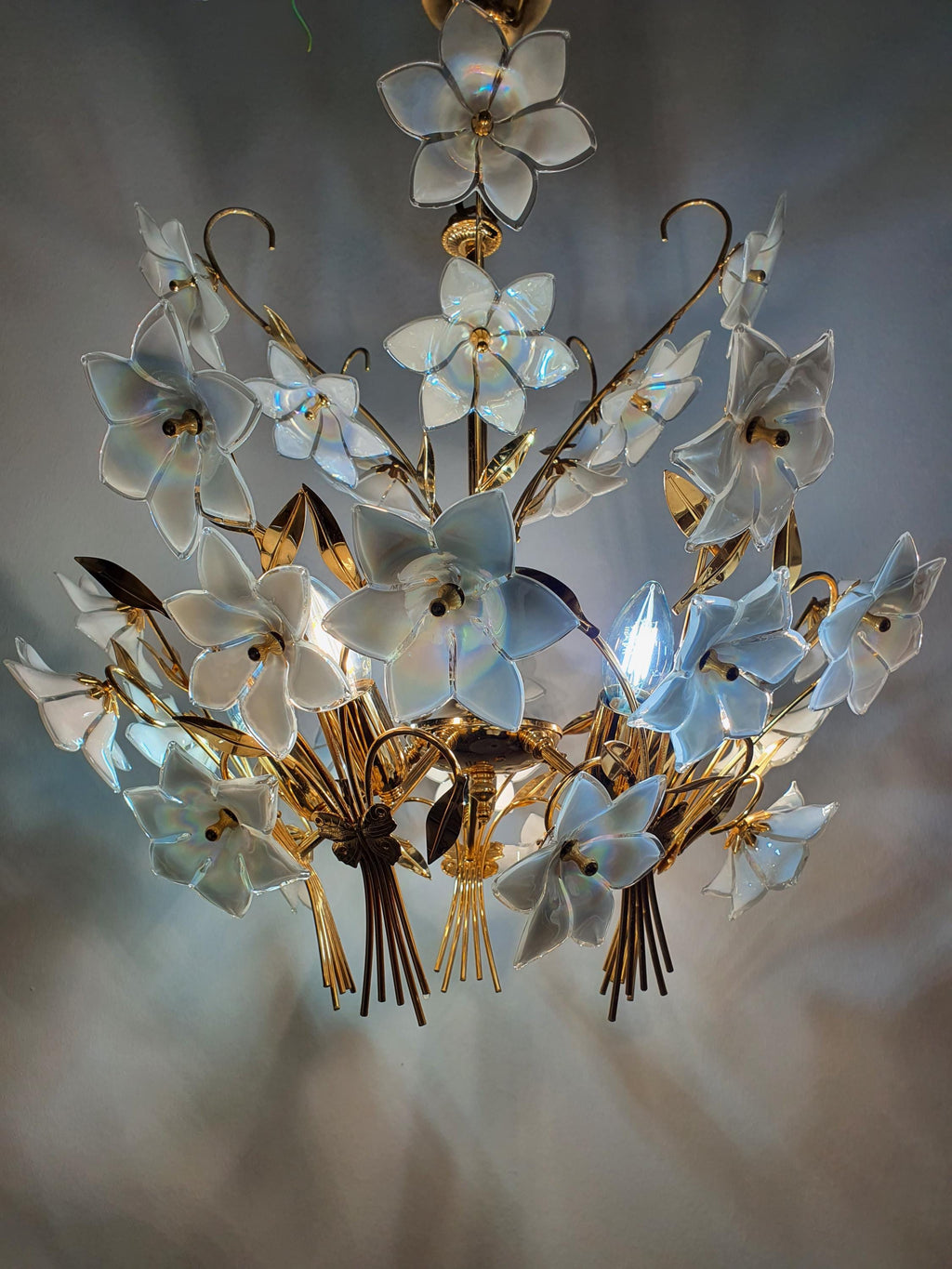 Iridescent colour shift detail on white Murano glass flower, petrol blue violet pink green reflections, bouquet chandelier
