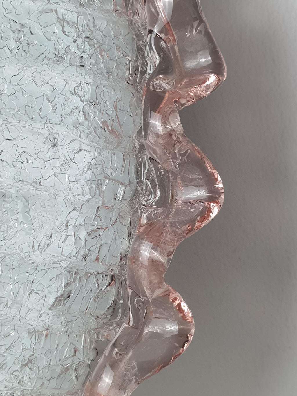 Close-up of frosted shell relief pattern and pink accent rim on vintage Murano glass floral flush mount