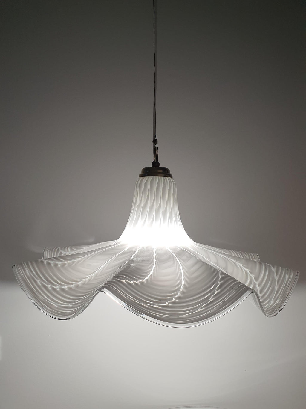 Vintage Italian Fazzoletto glass pendant lit, warm diffused glow through white wave Murano shade