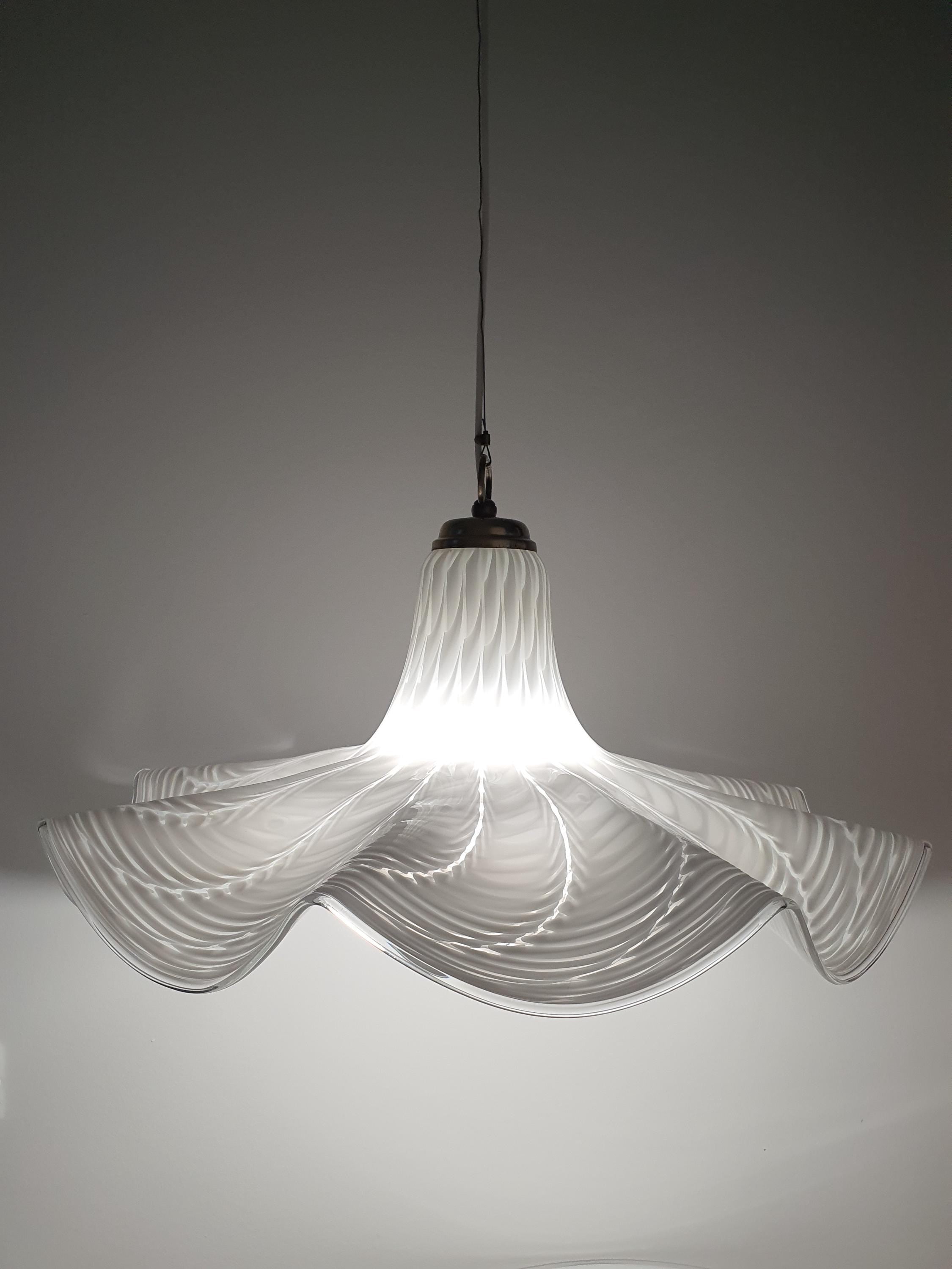 Vintage Italian Fazzoletto glass pendant lit, warm diffused glow through white wave Murano shade
