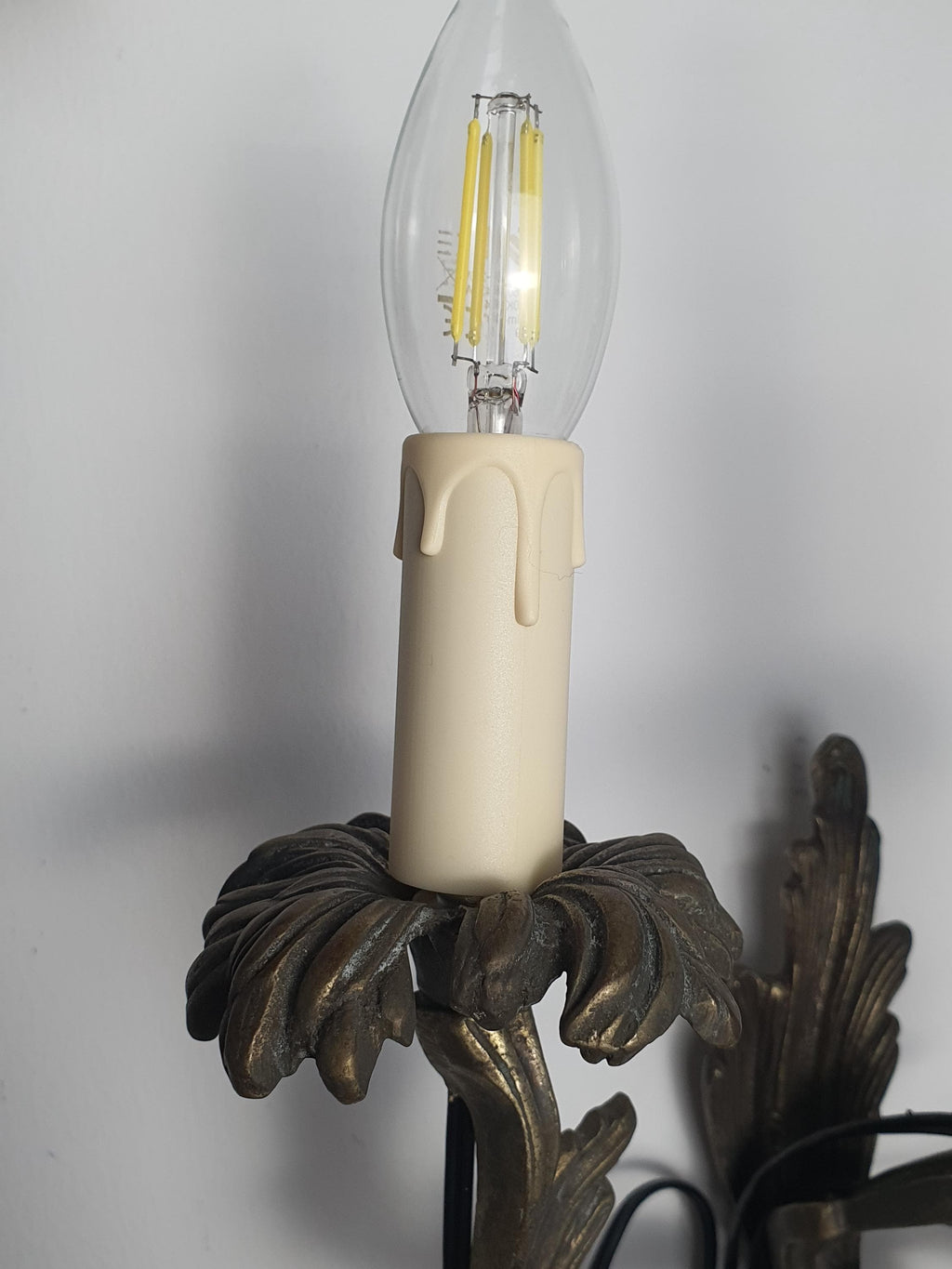Handcrafted Gothic candle sconce — sculptural dark grey metal texture, close-up