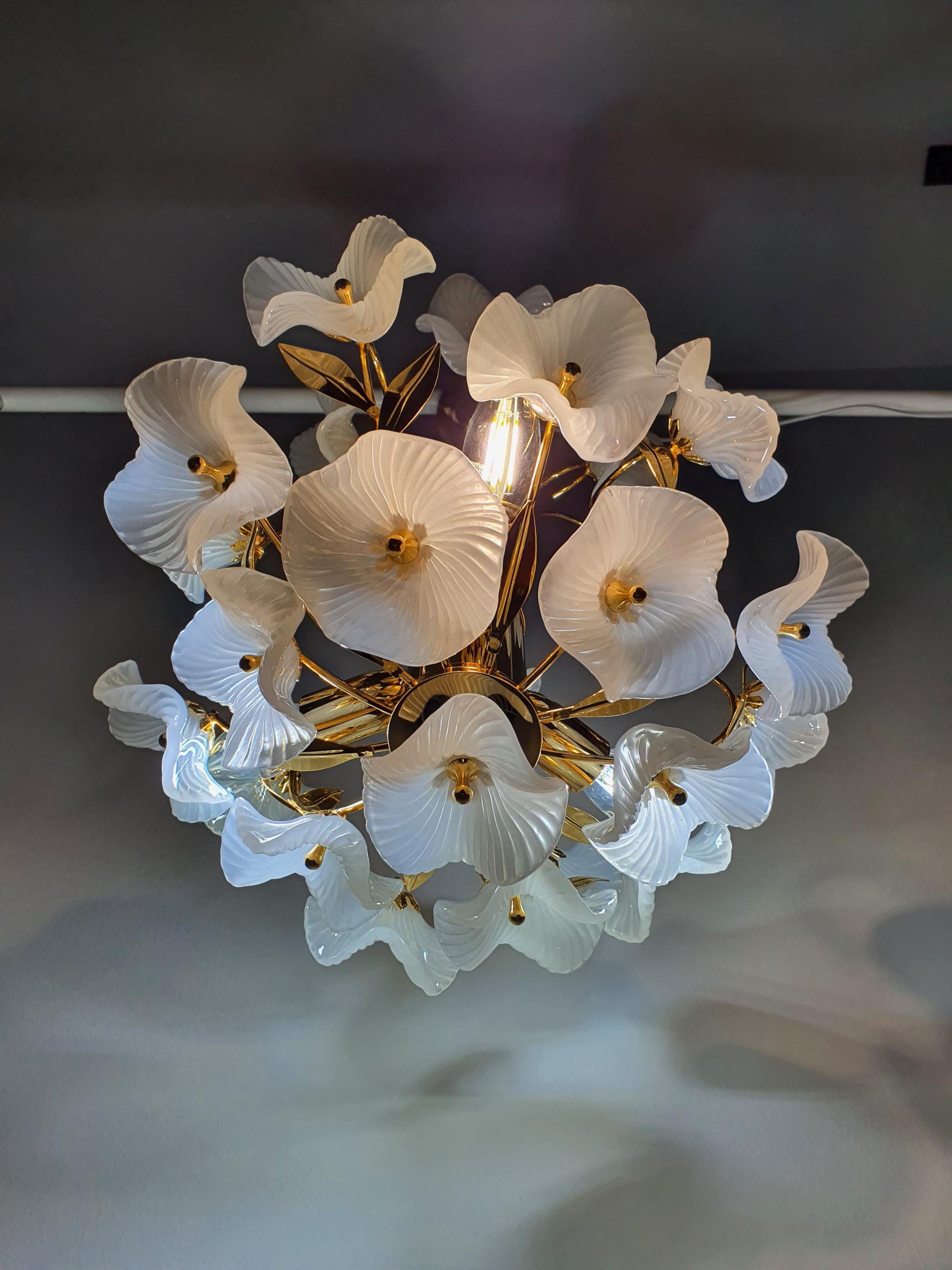 Vintage Murano white flower bouquet chandelier lit, soft gentle white glass petal glow, gold frame, romantic bedroom setting