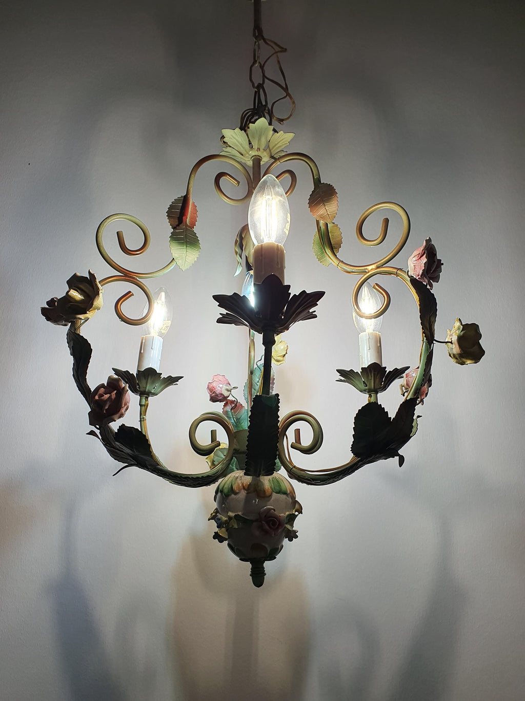 Vintage Italian tole chandelier installed in bedroom, romantic Mediterranean style