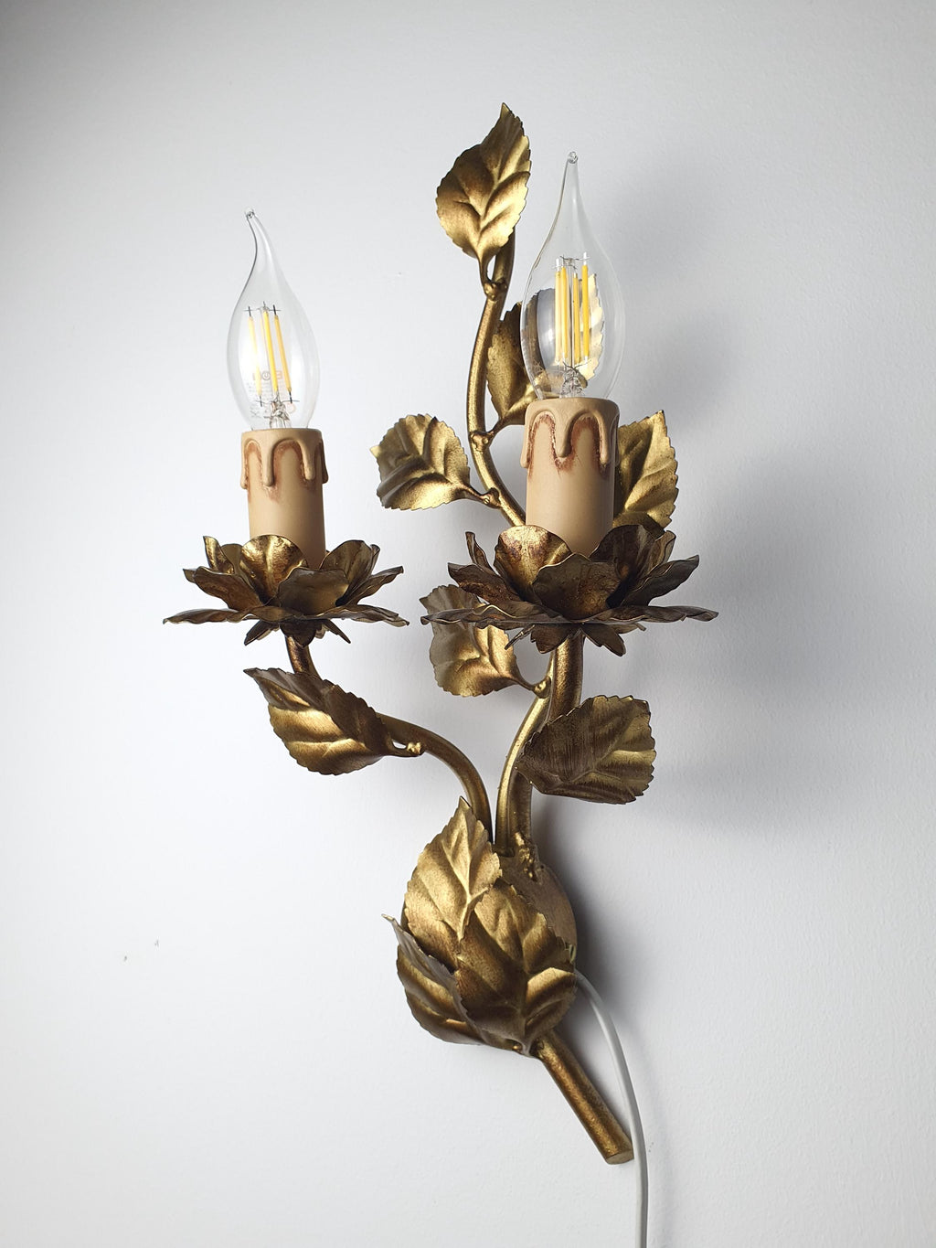 Larger botanical wall sconce with two candle-style light holders
