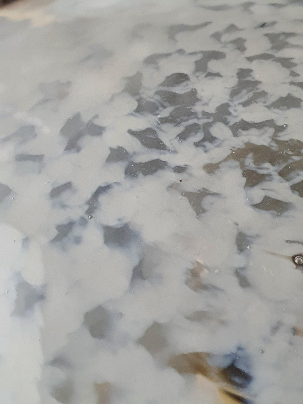 Close-up of white spotted moonstone effect in clear Murano glass globe table lamp shade, Vetri di Murano