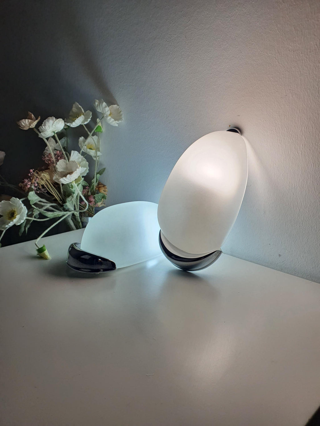 Pair of vintage Italian egg sconces lit, warm glare-free glow through satin frosted glass, bathroom installation