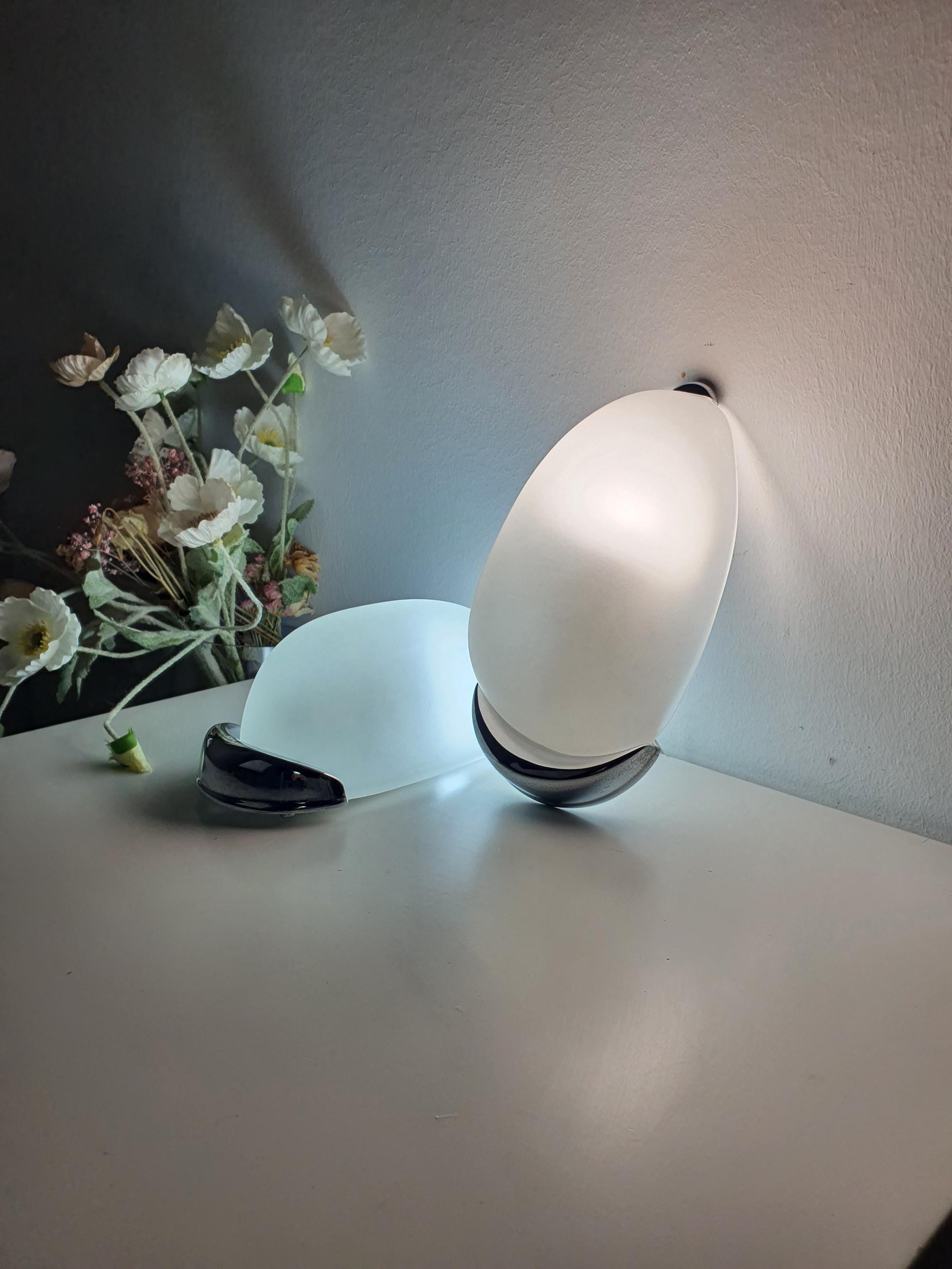 Pair of vintage Italian egg sconces lit, warm glare-free glow through satin frosted glass, bathroom installation