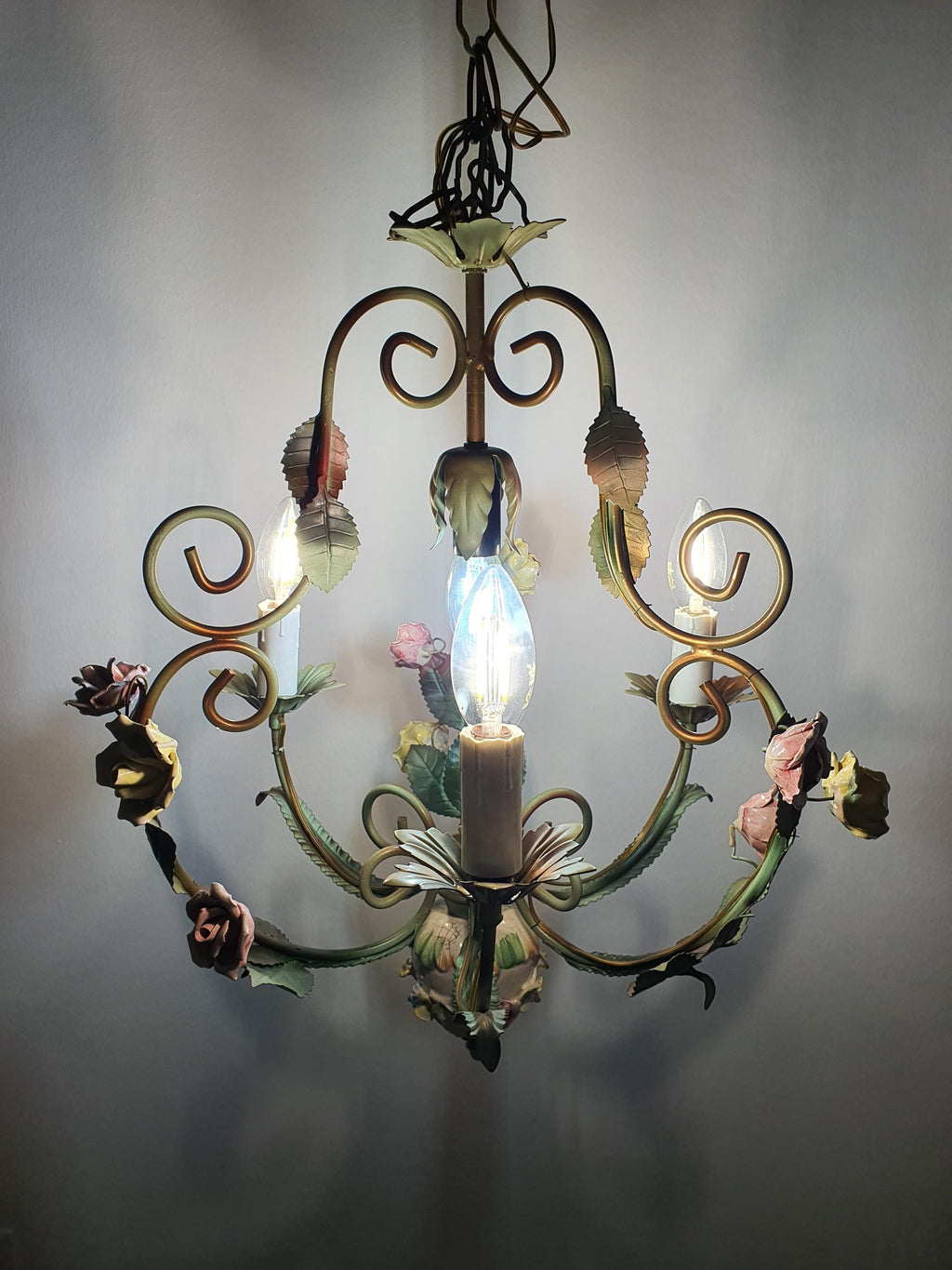 Vintage Italian cottage chandelier unlit, showing green painted metal and porcelain flowers
