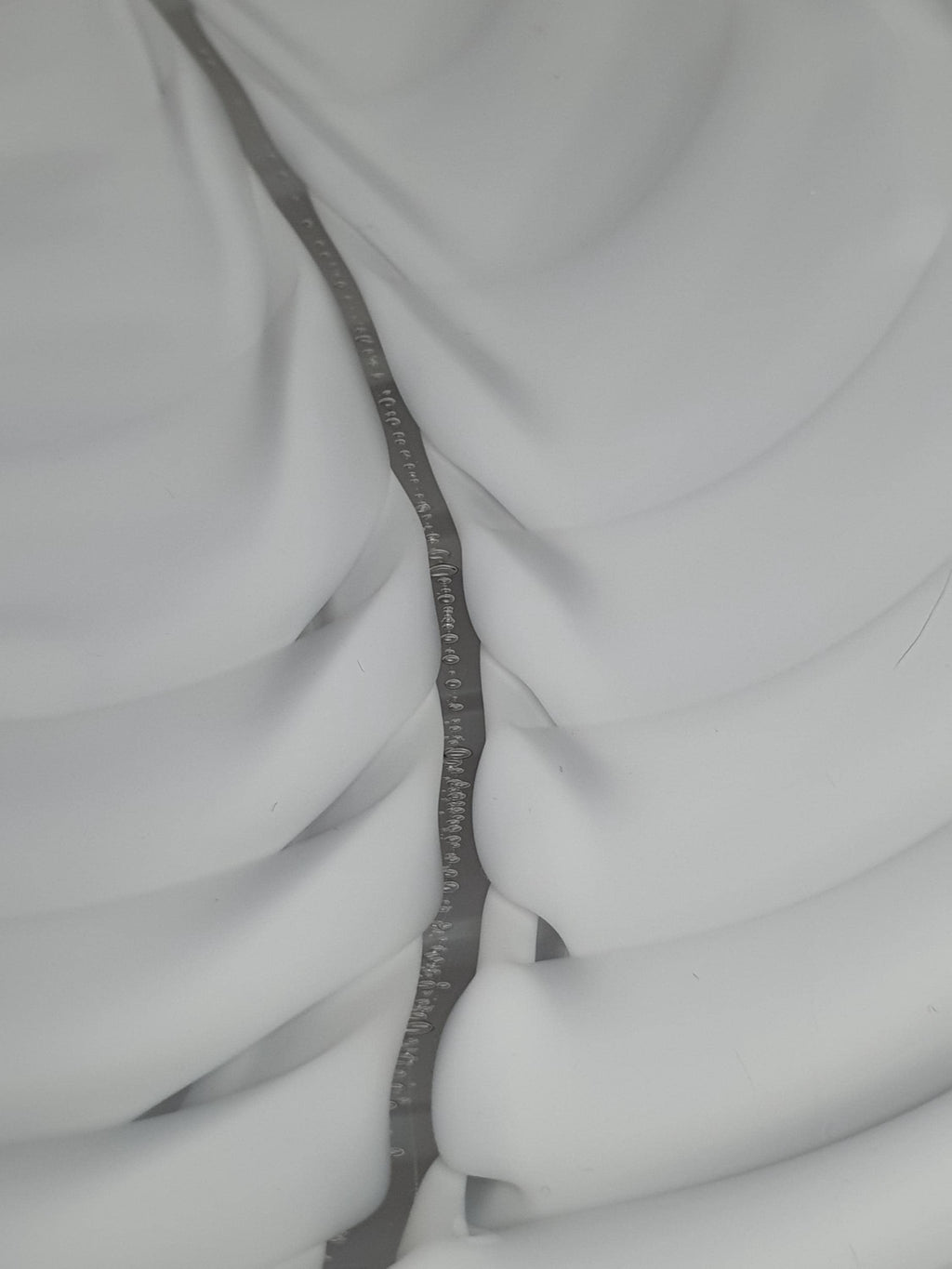 Close-up of white flowing wave folds in vintage Murano glass Fazzoletto pendant shade