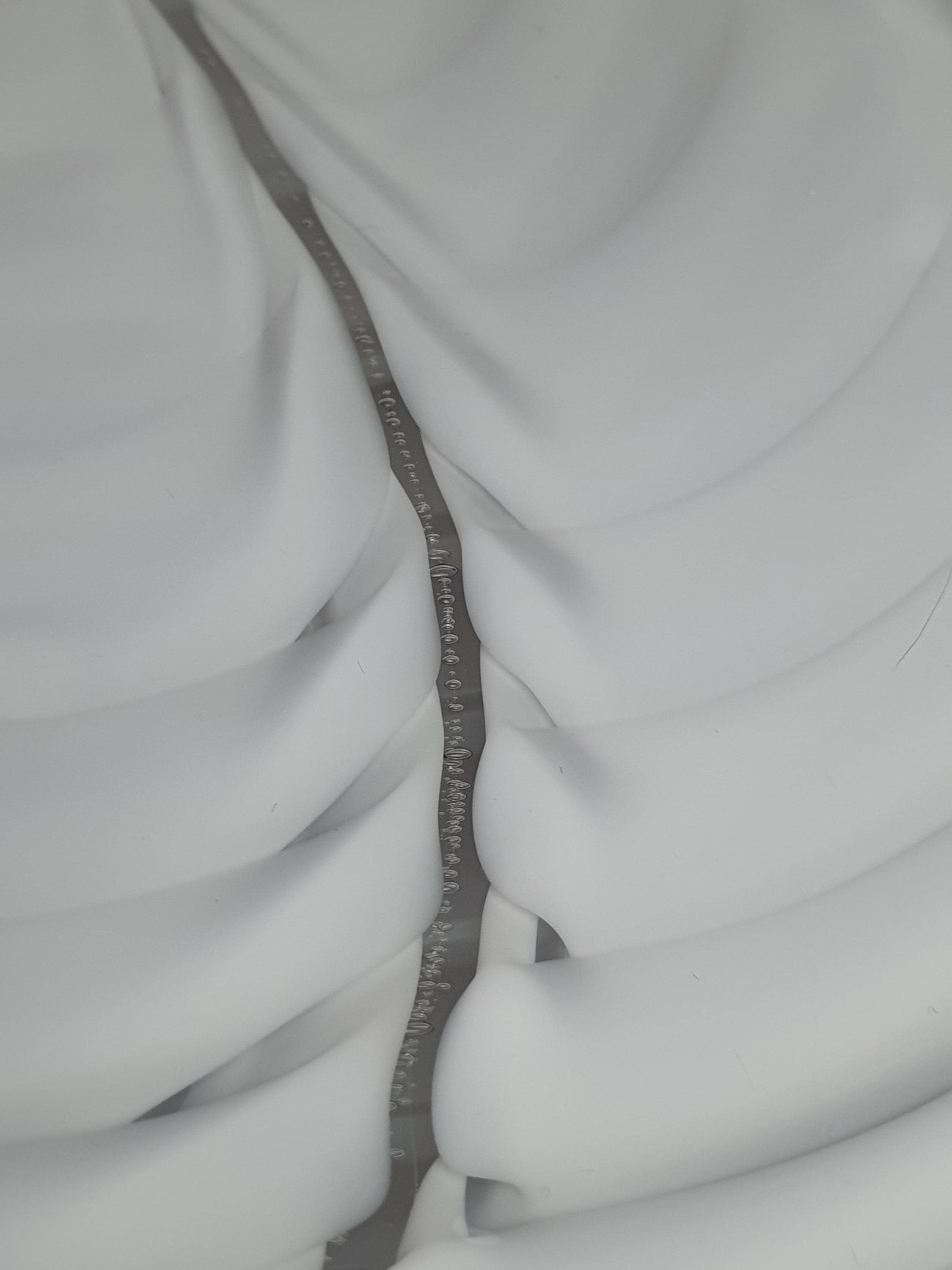 Close-up of white flowing wave folds in vintage Murano glass Fazzoletto pendant shade