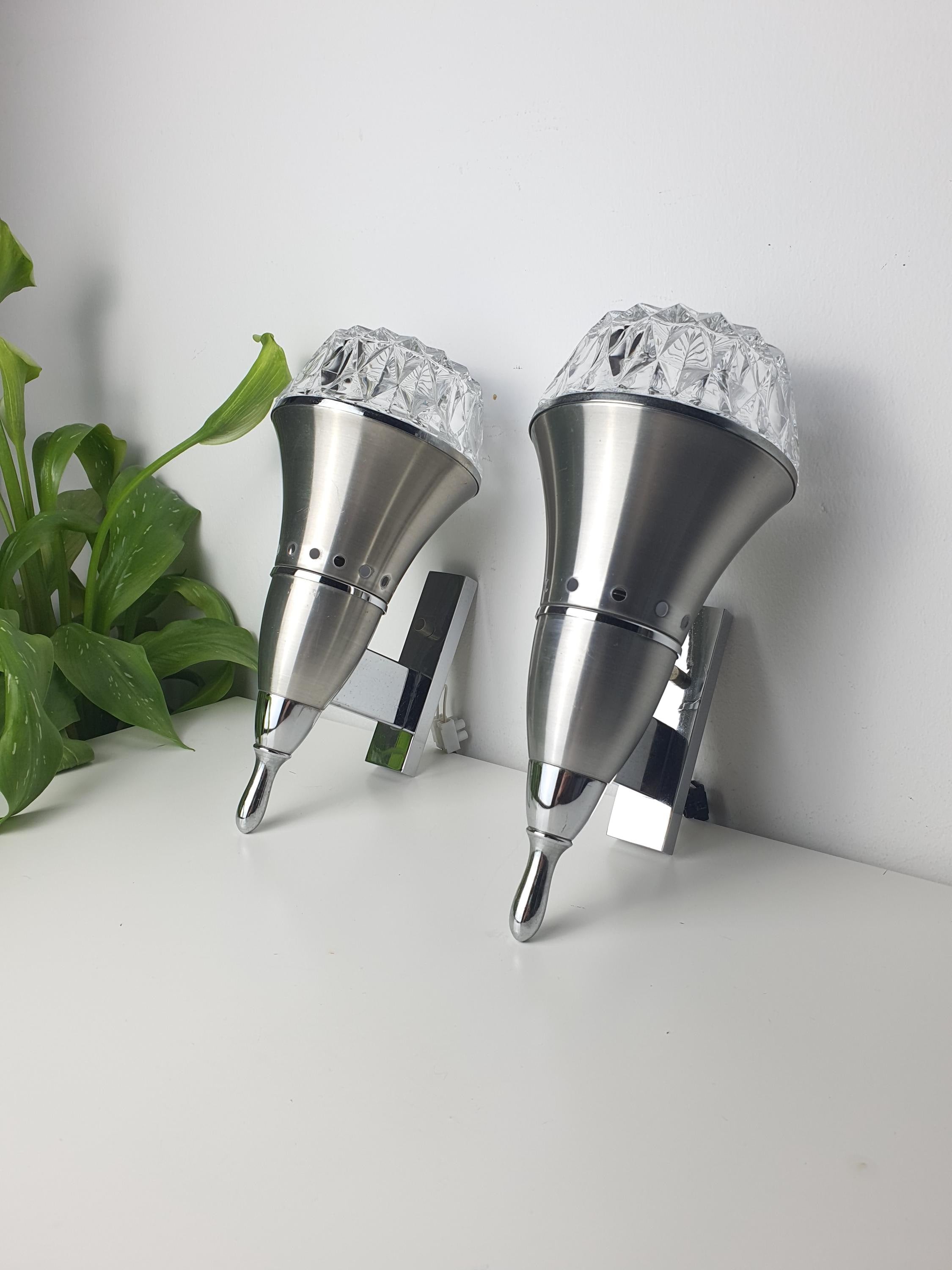 Set of 2 vintage Brutalist Space Age wall sconces — silver chrome metal and clear stamped glass, front view