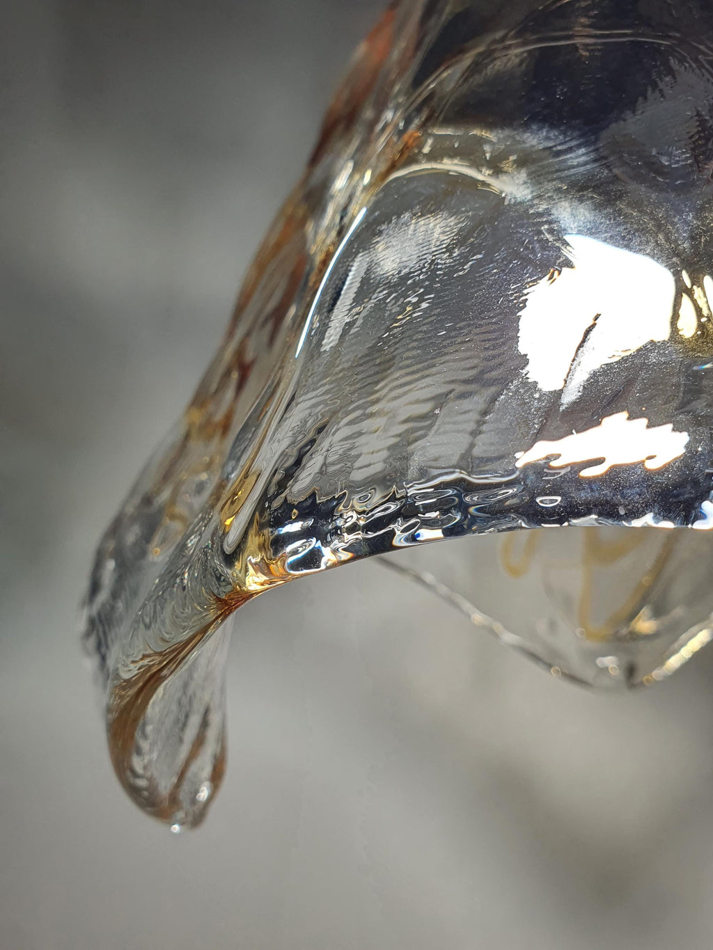 Flowing contours of a vintage La Murrina honey-drop glass pendant
