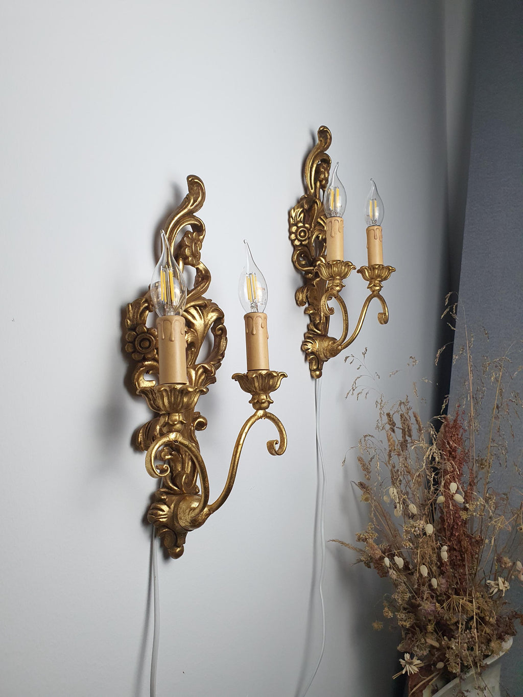 Scrolling carved details on an Italian Baroque-style wall sconce
