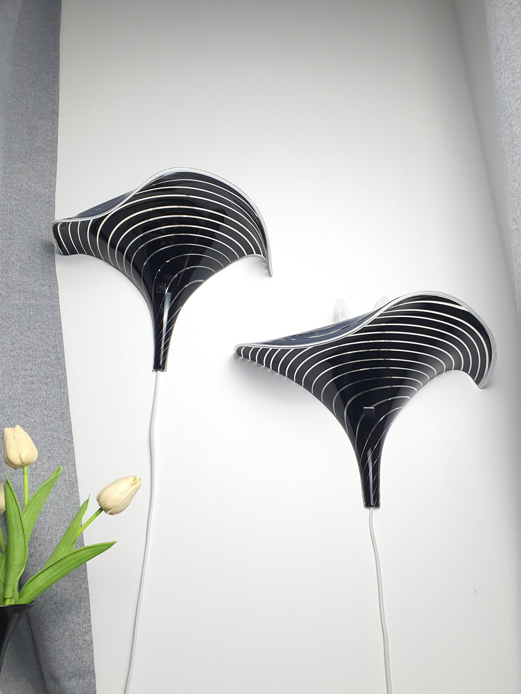 Pair of vintage Murano calla lily wall sconces in bedroom, black clear zebra stripe wave form, moody maximalist interior