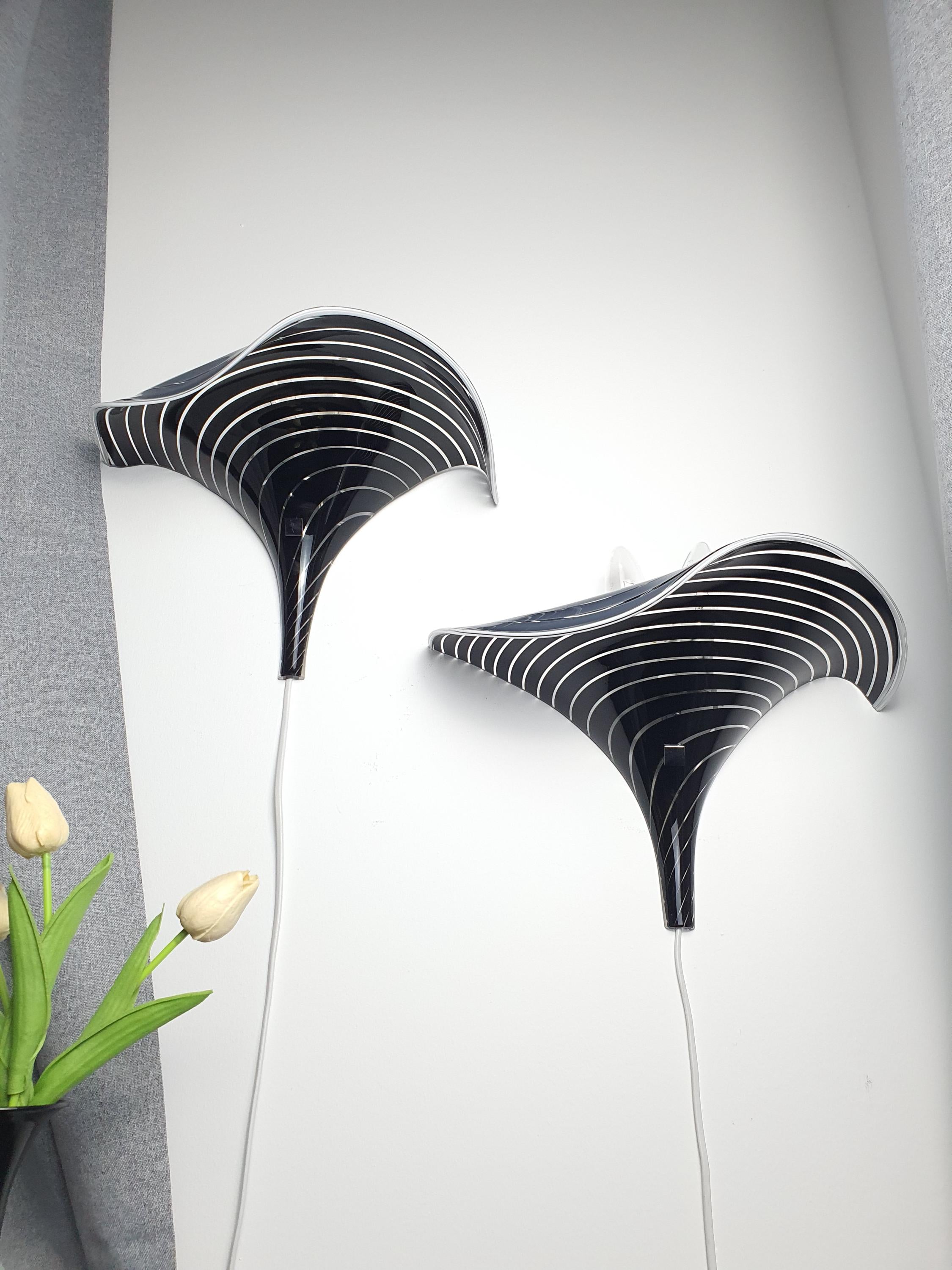 Pair of vintage Murano calla lily wall sconces in bedroom, black clear zebra stripe wave form, moody maximalist interior