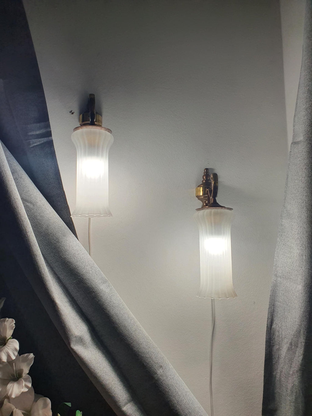 Pair of vintage Italian satin frosted flute wall sconces in bedroom, soft warm glow, brass bases, classical MCM interior