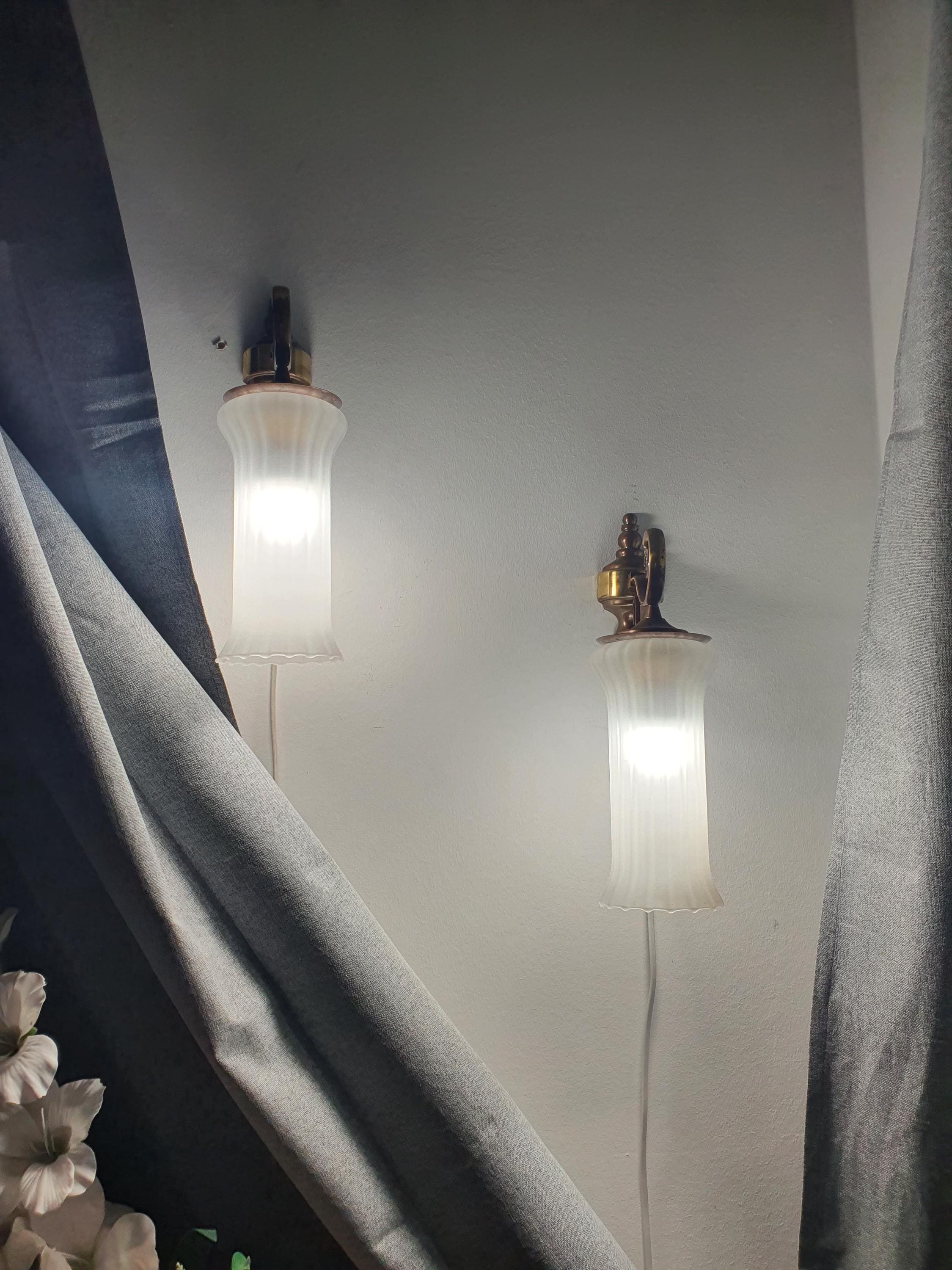 Pair of vintage Italian satin frosted flute wall sconces in bedroom, soft warm glow, brass bases, classical MCM interior