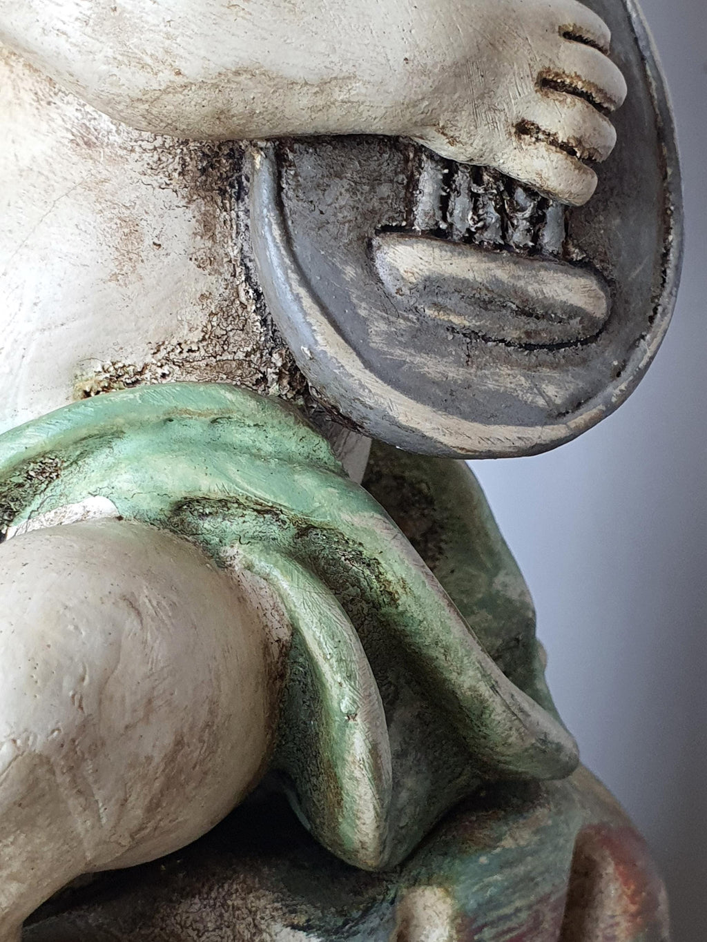 Pair of Italian cherub angel table lamps unlit, showing hand-painted wooden figures and fabric shade texture