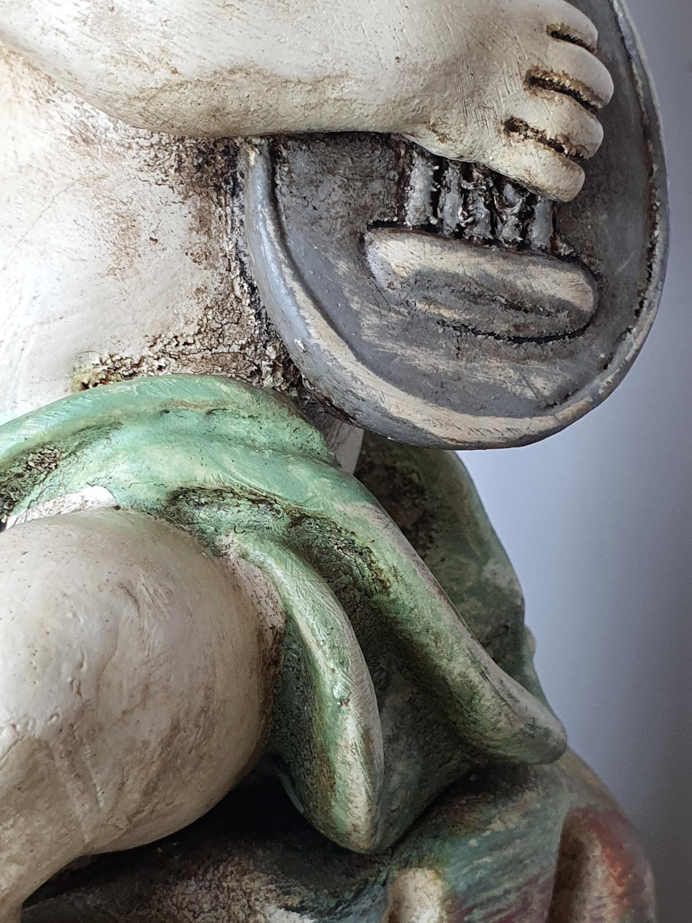 Pair of Italian cherub angel table lamps unlit, showing hand-painted wooden figures and fabric shade texture