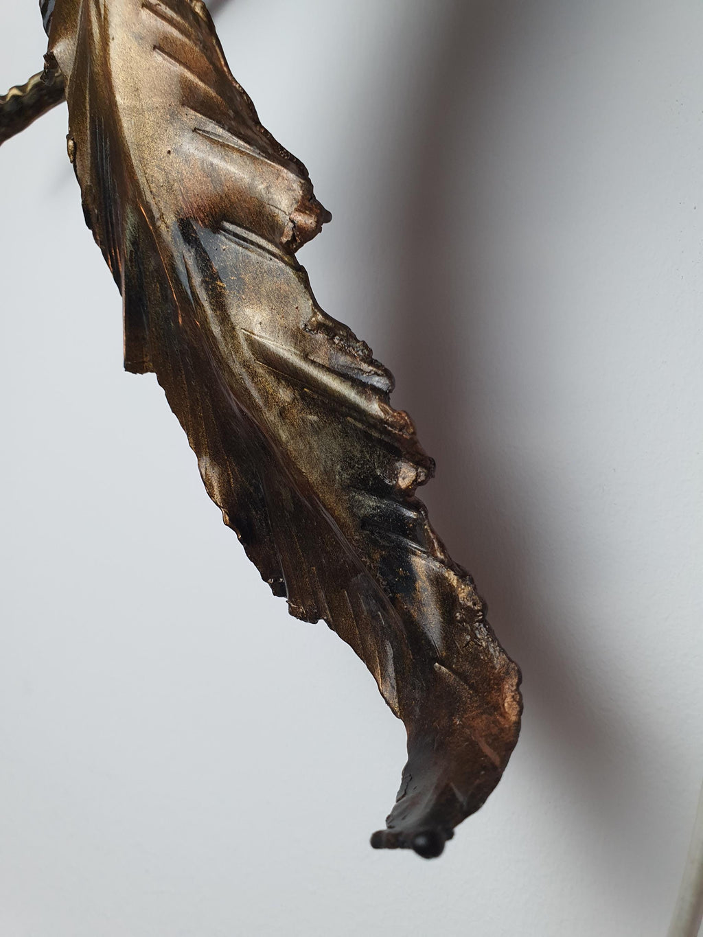 Bronze and gilded finish on hand-shaped metal foliage
