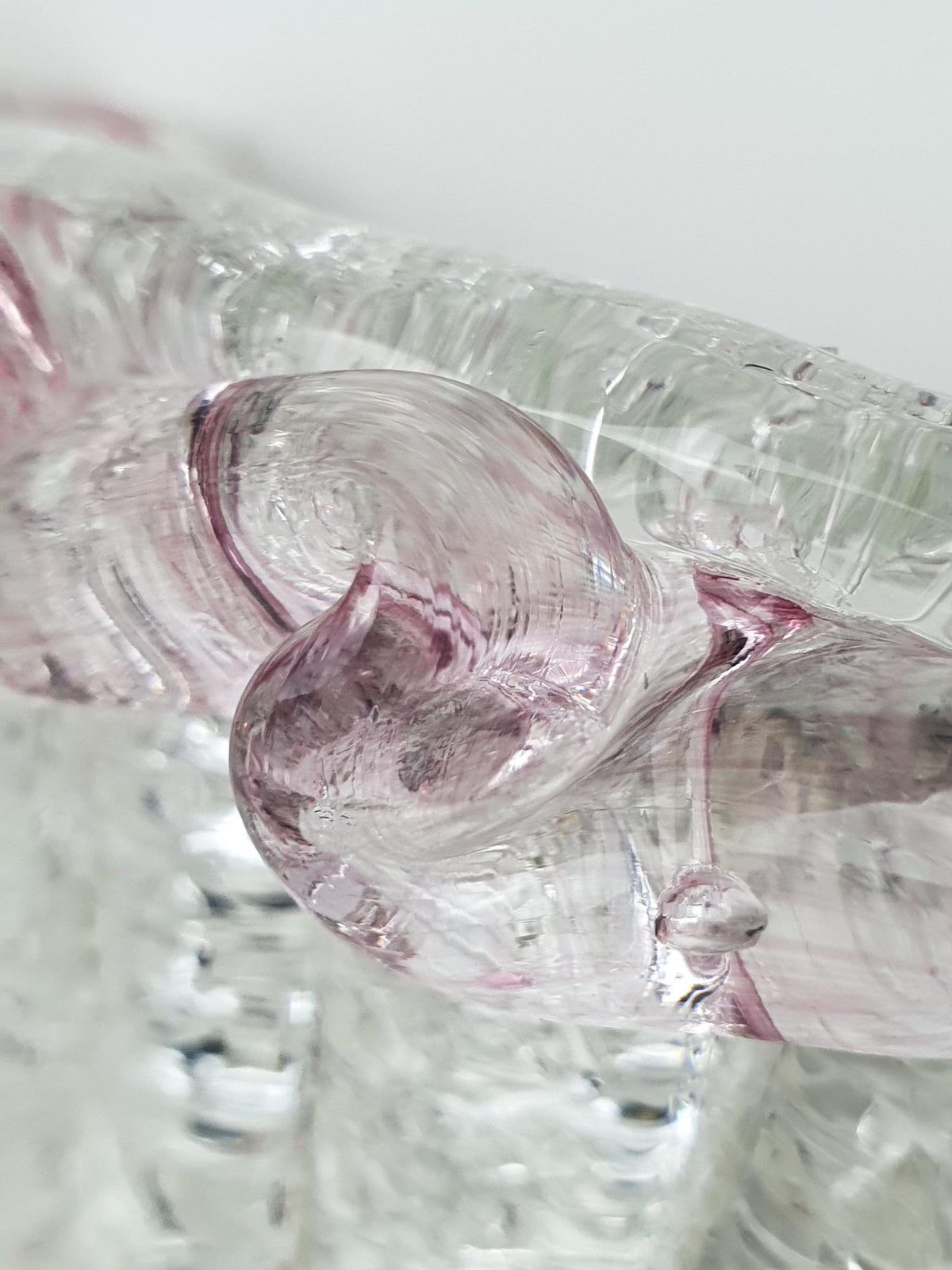 Detail of soft pink tones in the granular glass border
