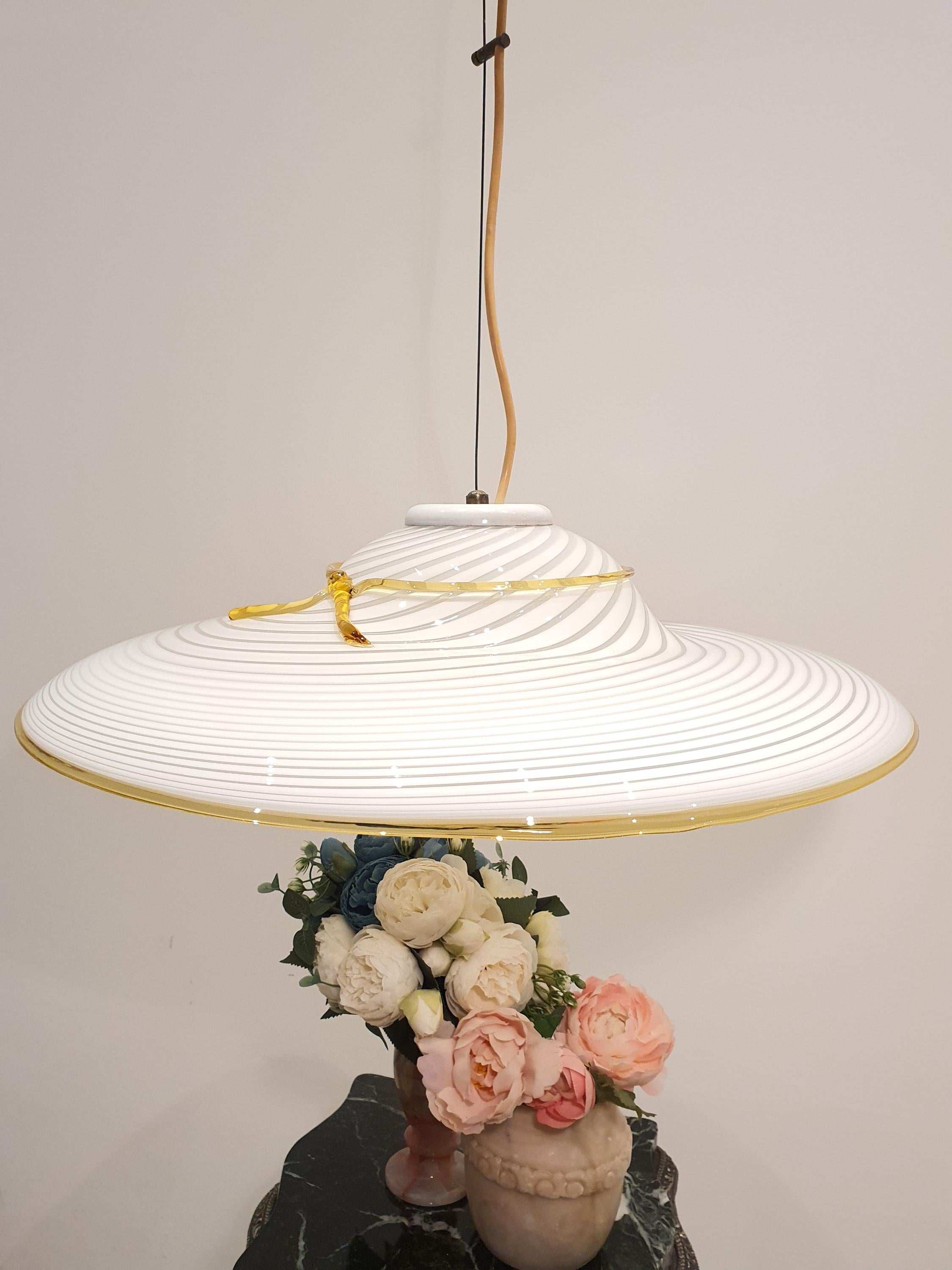 Italian Murano glass pendant — white swirl and yellow bow, dining area setting