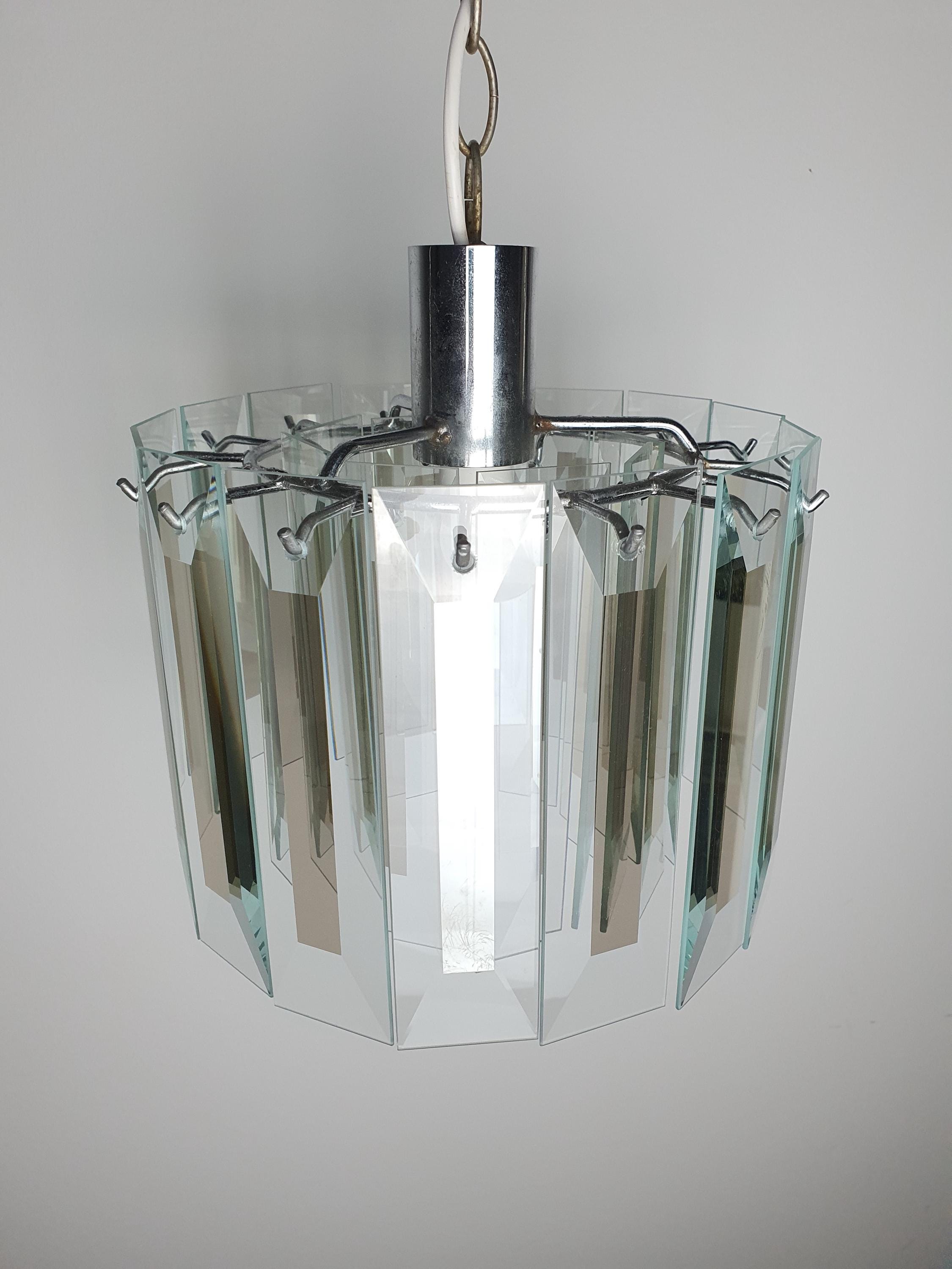 Close-up of aged chrome frame with oxidation patina on vintage Art Deco chandelier, authentic decades-old vintage character