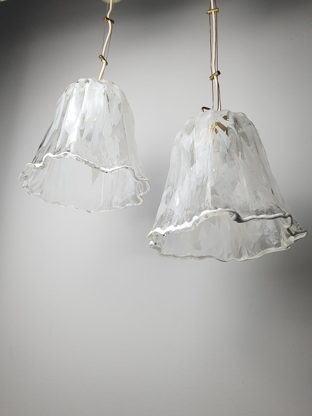 Floral-inspired white and clear Fazzoletto glass shades on vintage La Murrina pendants
