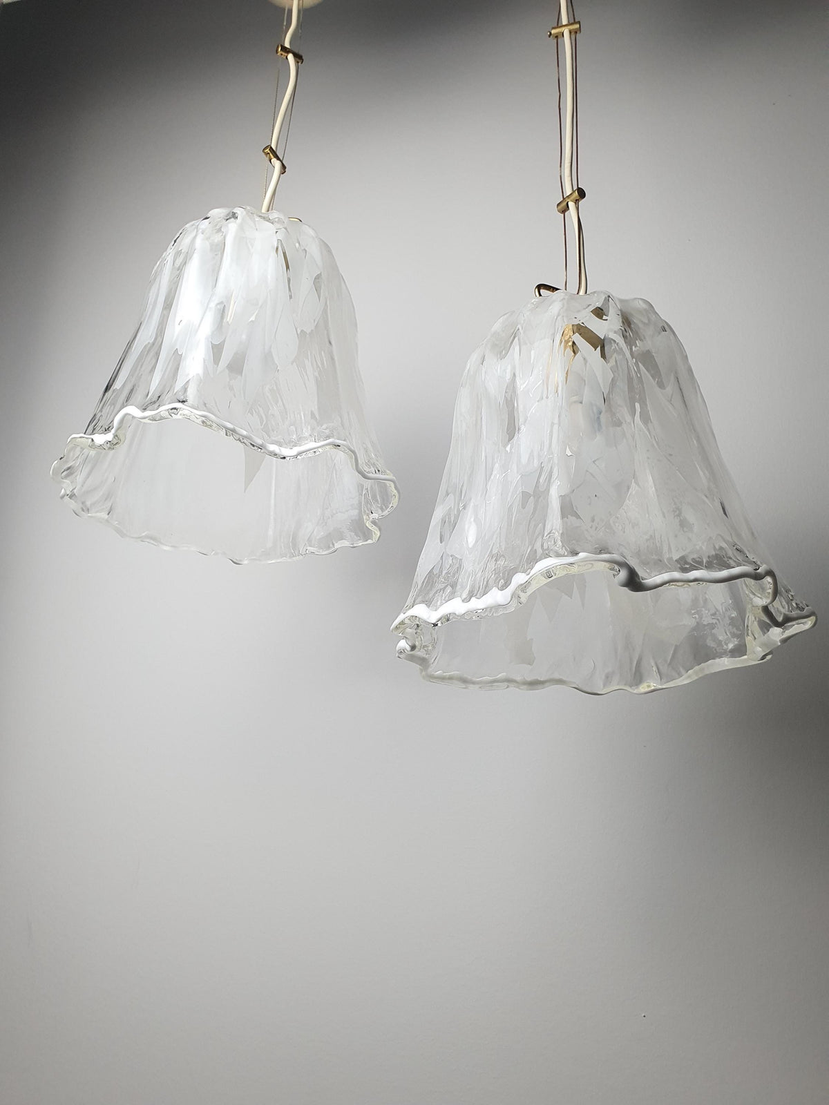 Floral-inspired white and clear Fazzoletto glass shades on vintage La Murrina pendants
