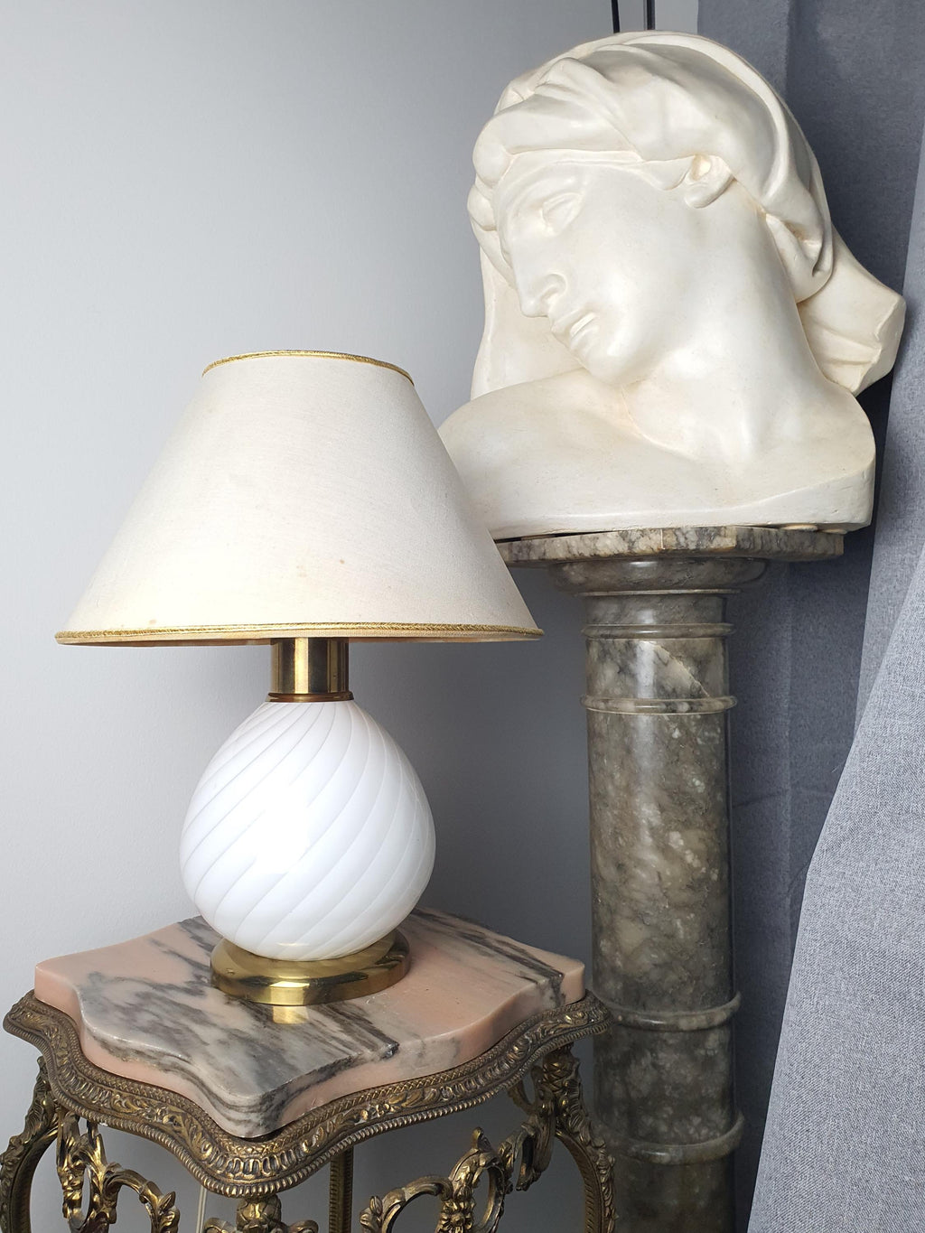 Vintage Murano white candy swirl bedside lamp on bedside table, warm cosy glow, Scandinavian Japandi bedroom interior