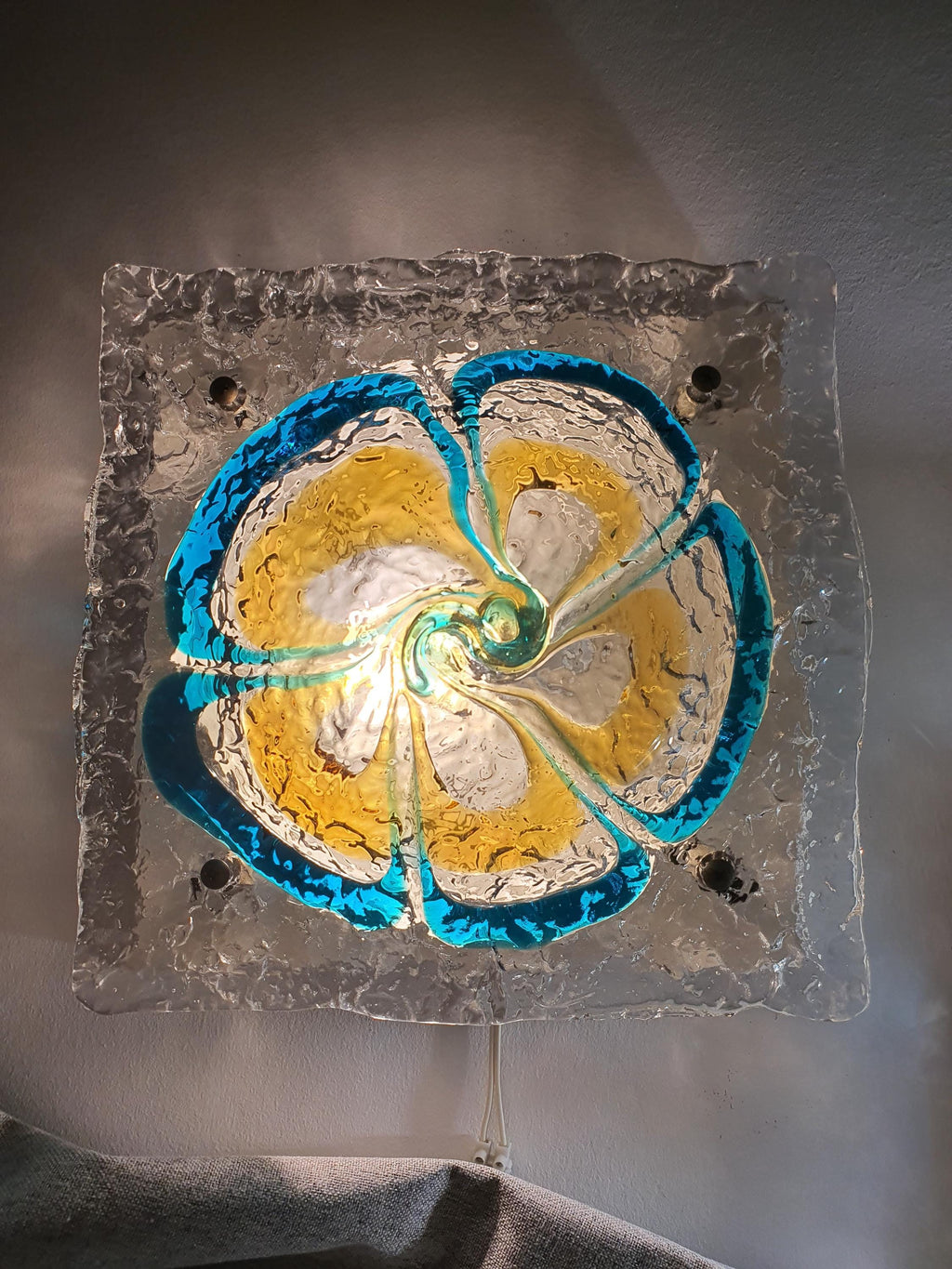 Pair of vintage Mazzega Murano floral sconces unlit, showing turquoise caramel clear glass petal silhouette