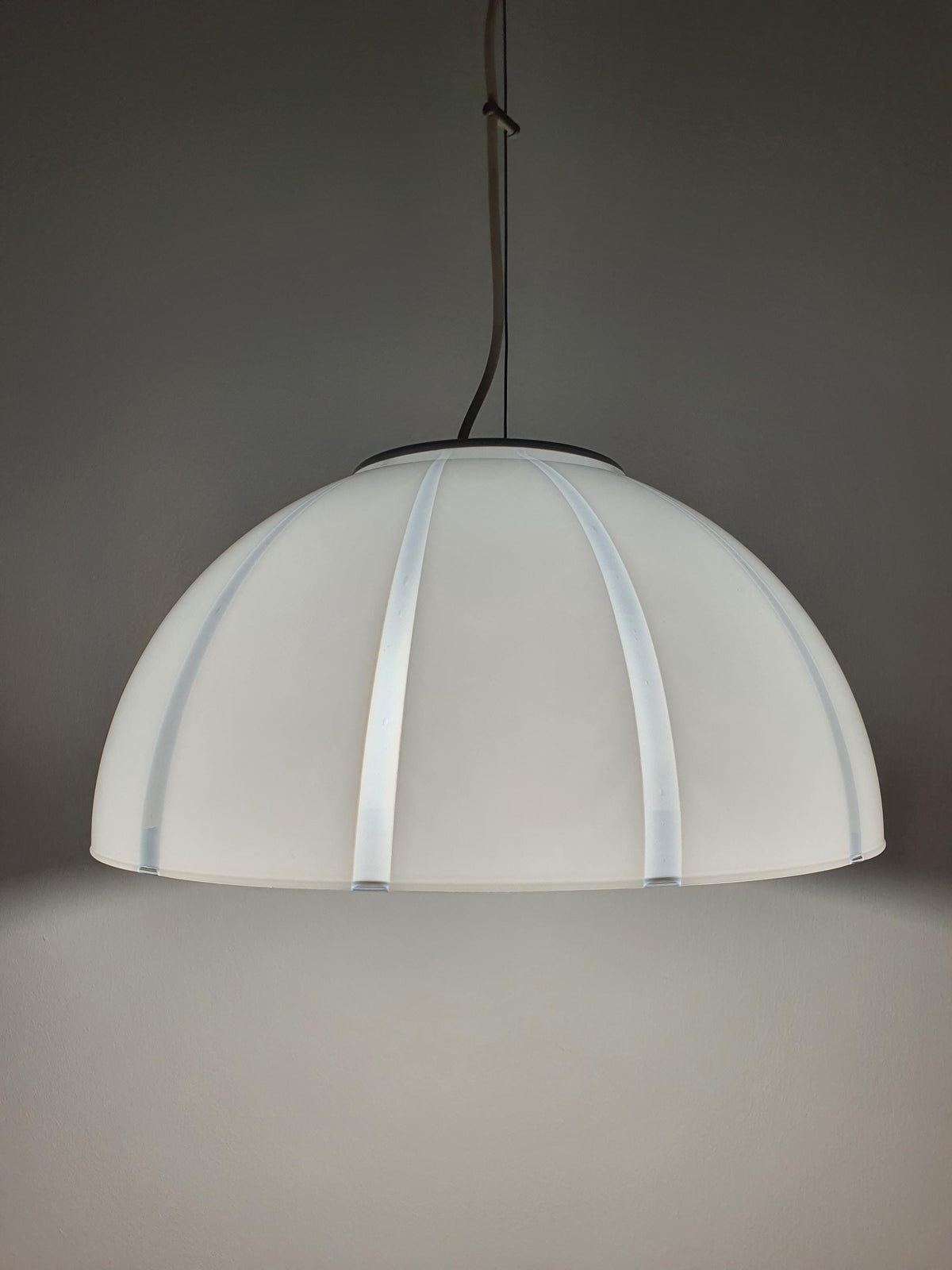 Gold-toned canopy detail on vintage Murano white and clear striped bell pendant, warm metal contrast to crisp glass