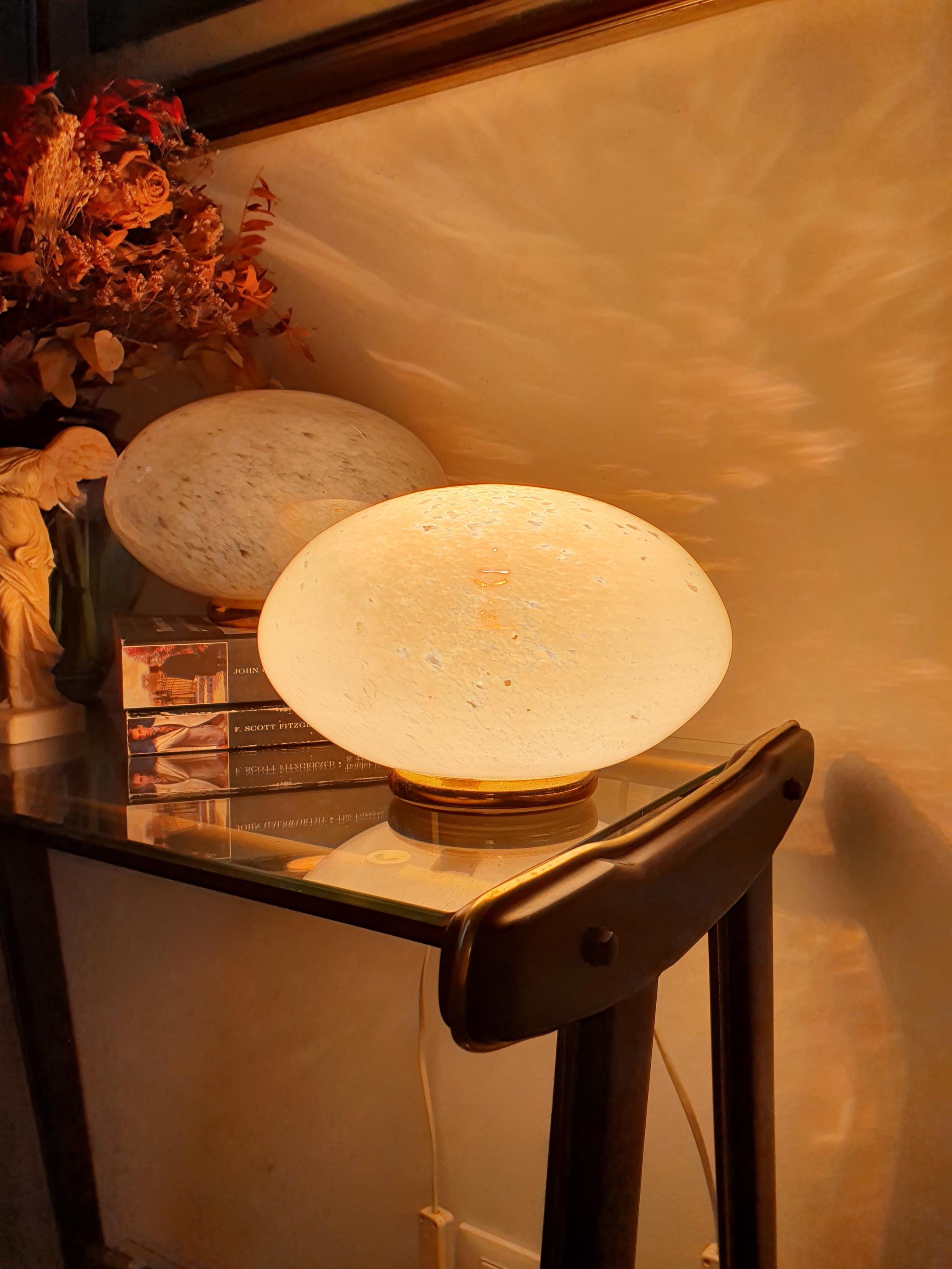 Pair of Vetri di Murano globe lamps lit, warm moonstone glow through white spotted clear glass shades