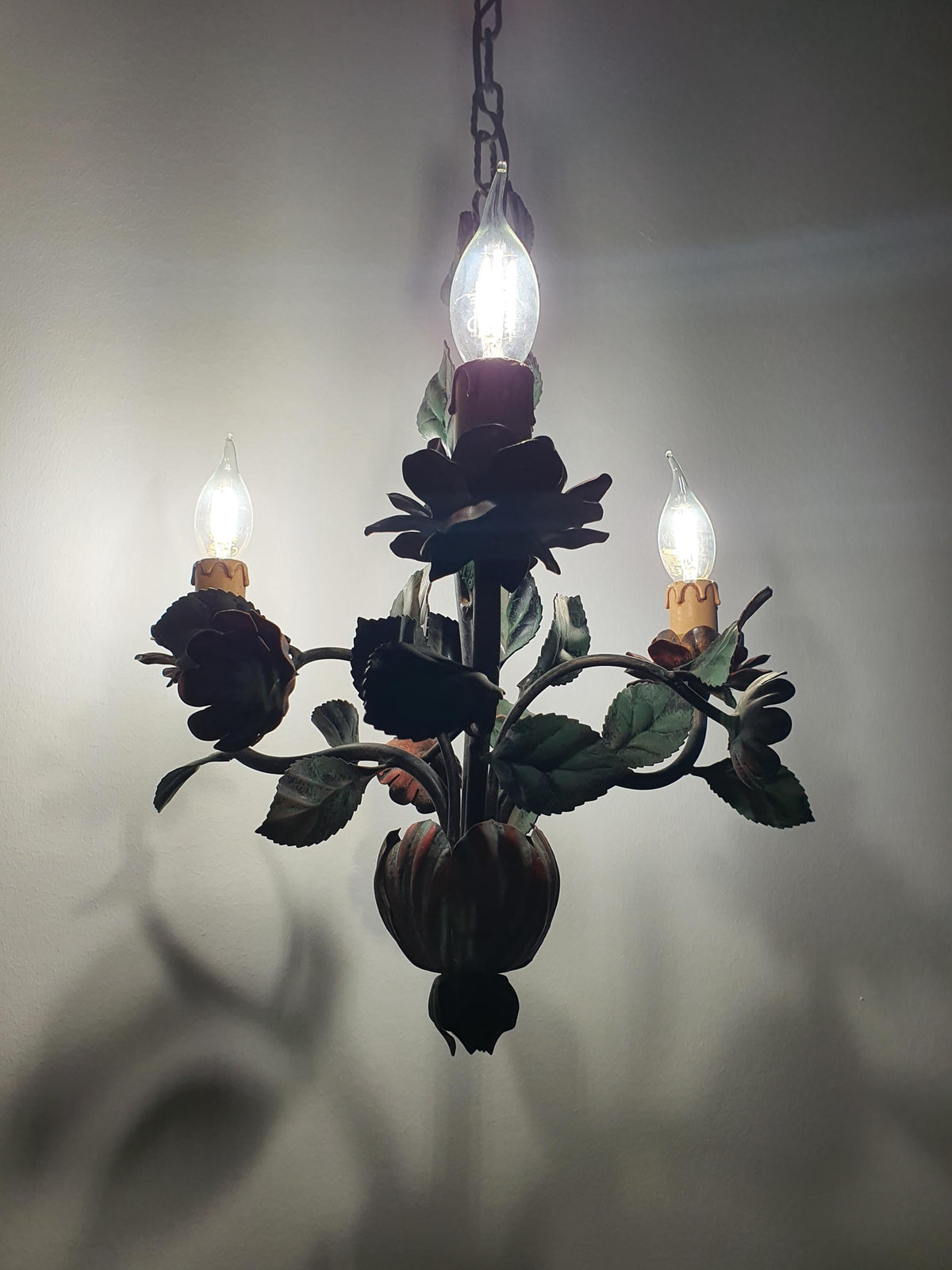 Three-arm candle-style chandelier with handcrafted red flowers and green foliage
