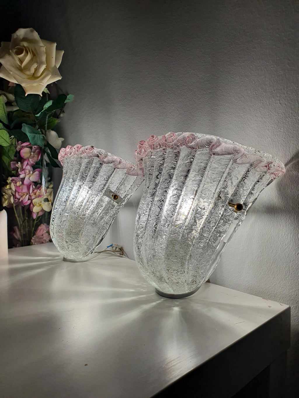 Organic flower-shaped glass shade on a vintage Italian wall light
