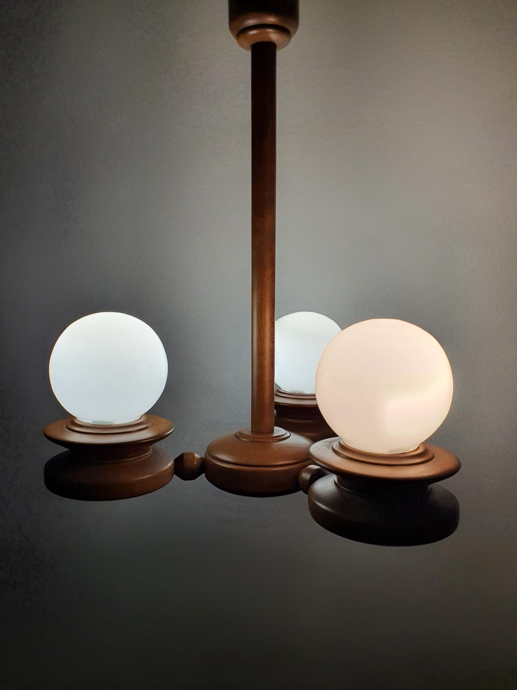 Vintage Space Age Sputnik chandelier in bedroom, soft milk glass globe light, solid wood, cosy Scandinavian rustic interior