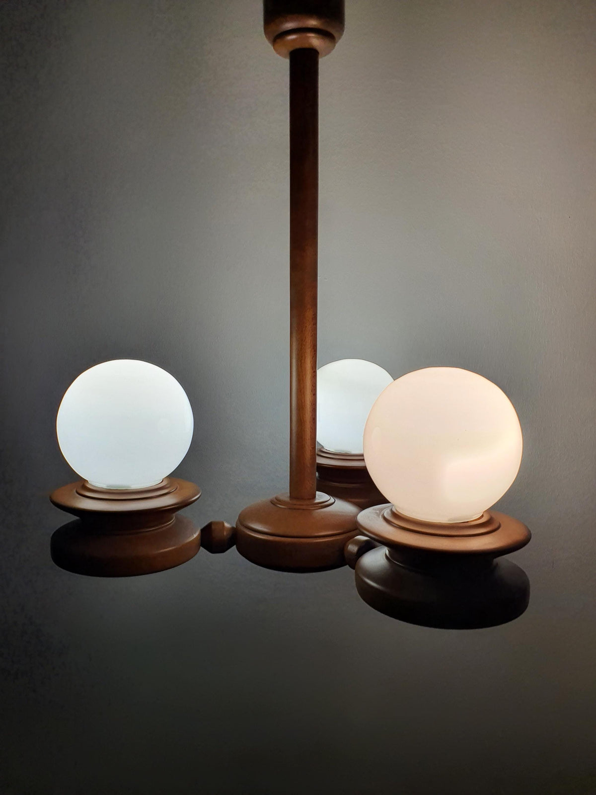 Vintage Space Age Sputnik chandelier in bedroom, soft milk glass globe light, solid wood, cosy Scandinavian rustic interior