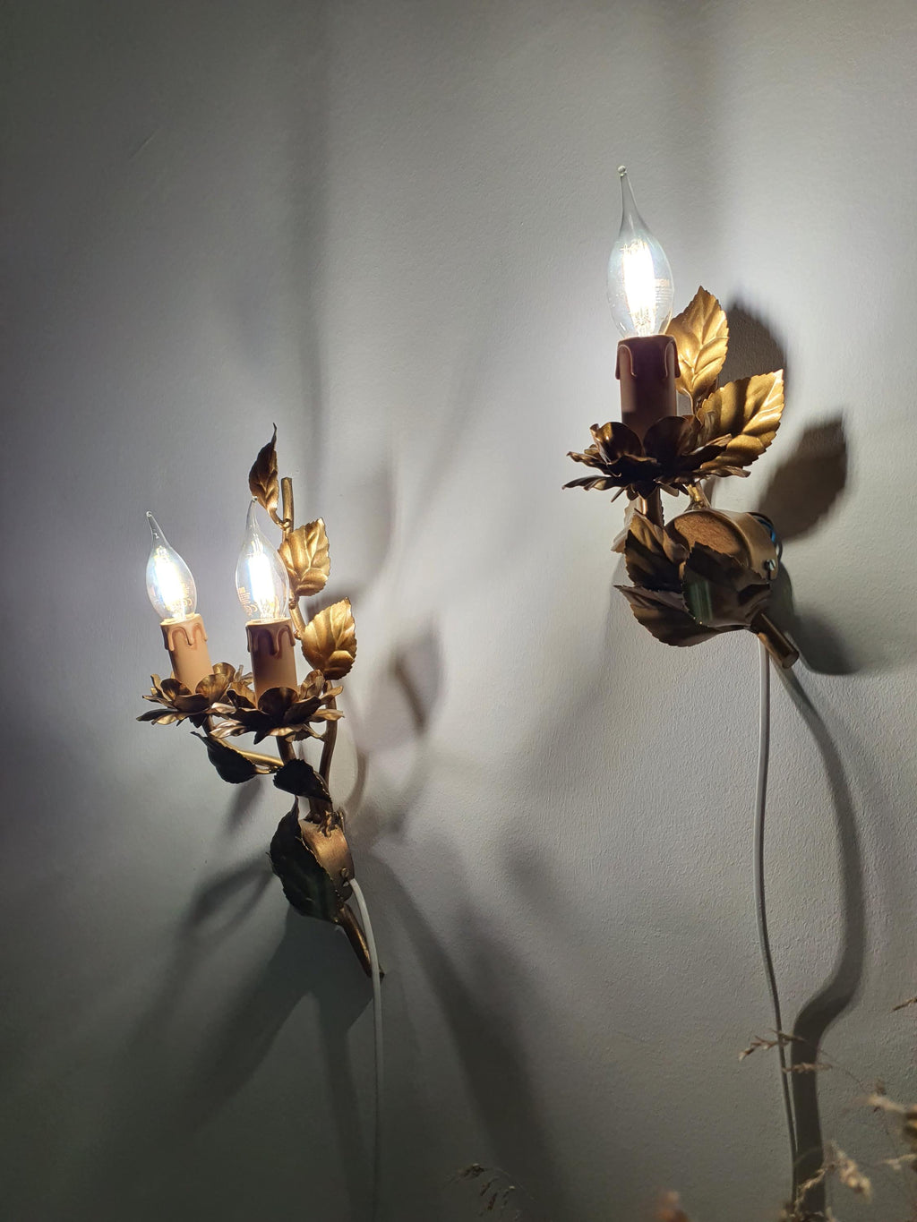 Sculpted metal leaves and stems on a vintage floral tole sconce
