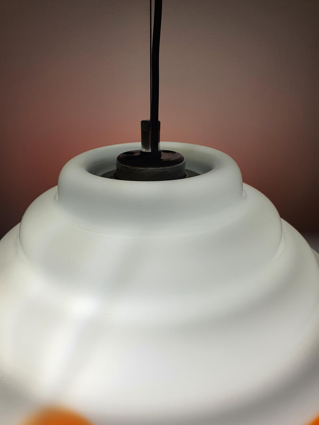 Murano glass orange white pendant — illuminated, warm internal glow through white glass