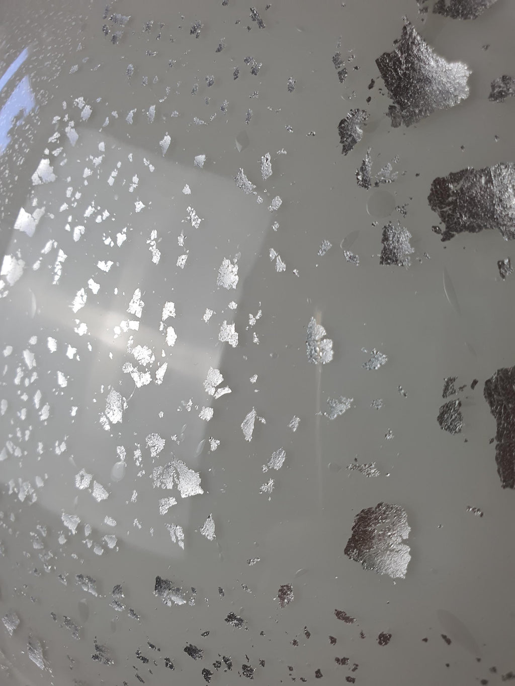 Close-up of organic sculptural edge on vintage Murano white silver aventurine flush mount, soft white glass form detail