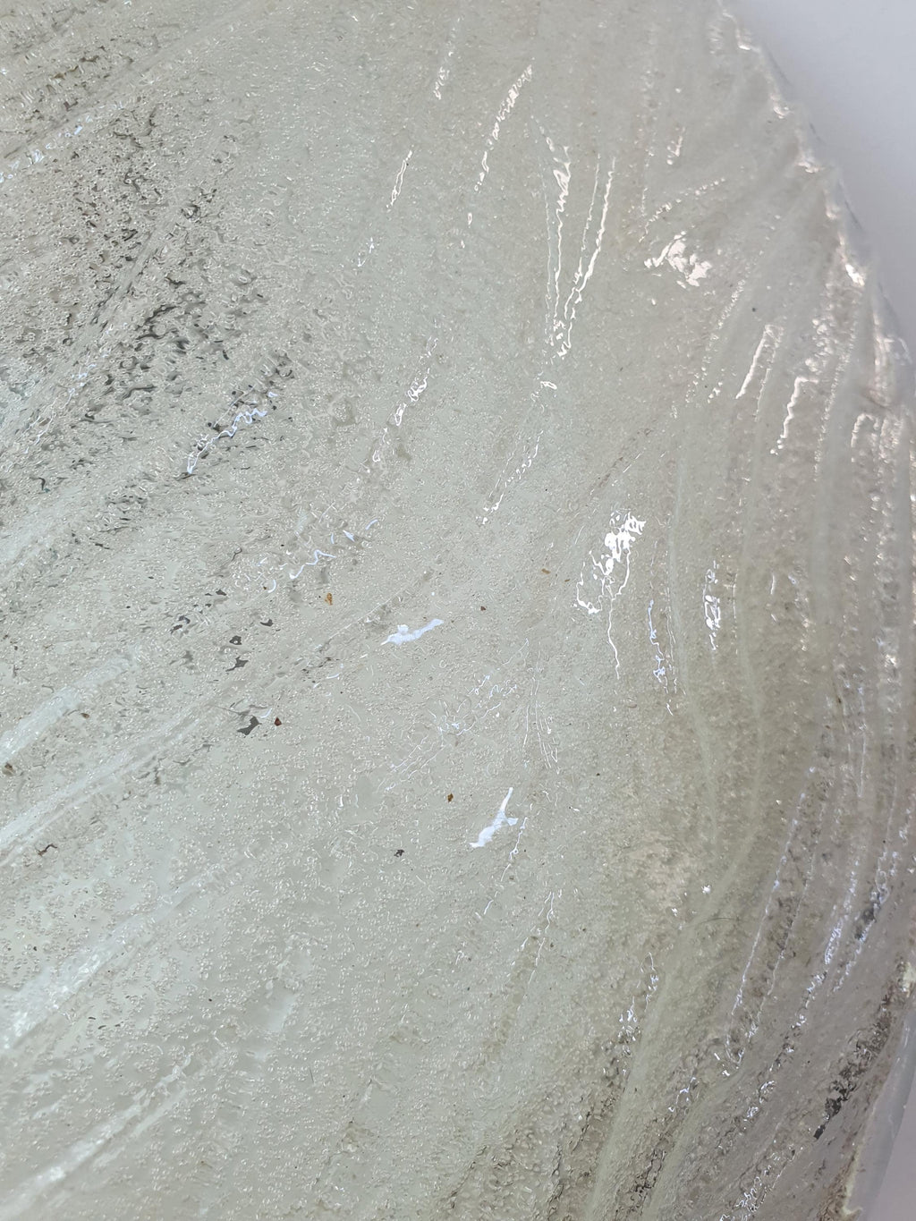 Close-up of glass-sand textured reverse on vintage Venetian shell flush mount, smooth clear front and iced sand diffused back