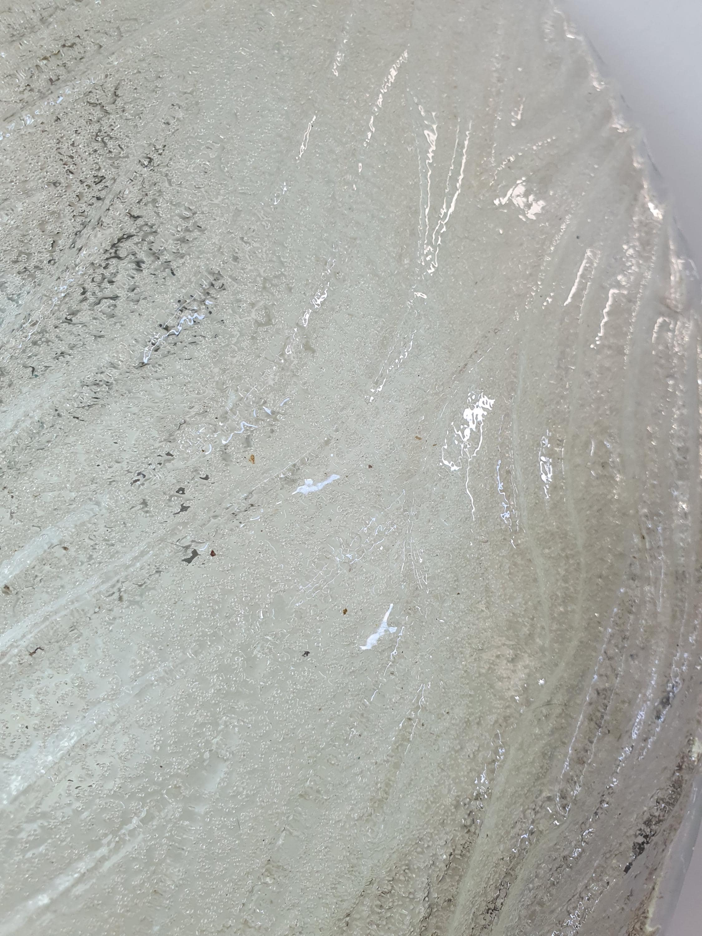 Close-up of glass-sand textured reverse on vintage Venetian shell flush mount, smooth clear front and iced sand diffused back
