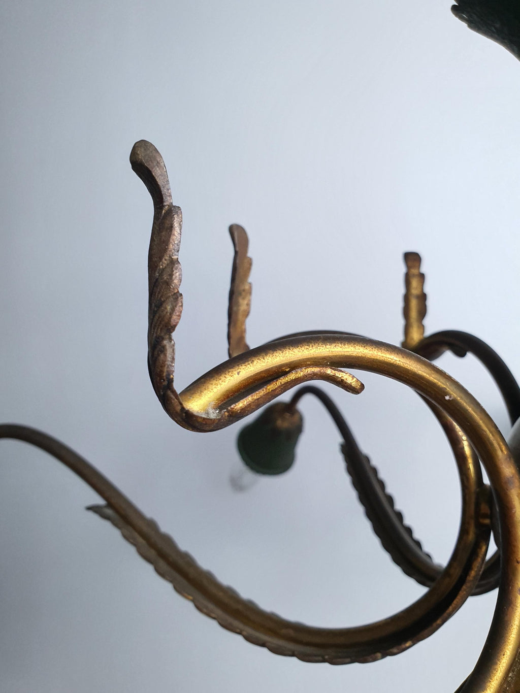Close-up of decorative bronze leaf motif on vintage 1950s Italian Sputnik chandelier, botanical detail on brass arm