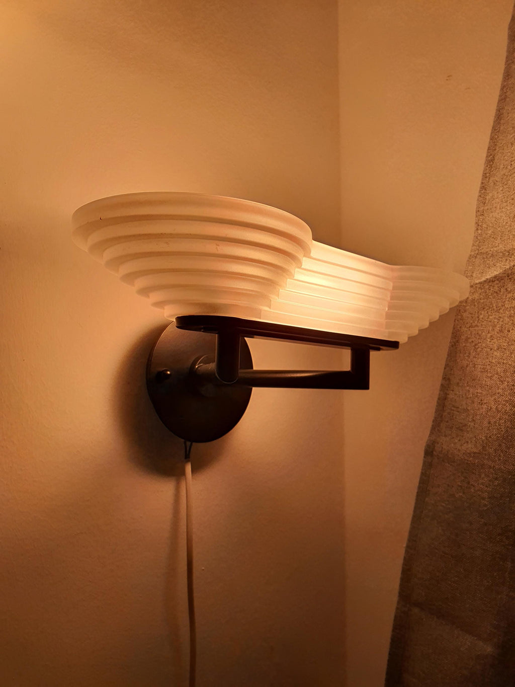 Black metal base detail on vintage Italian Memphis Postmodern wall light, graphic architectural framework, satin glass diffuser

