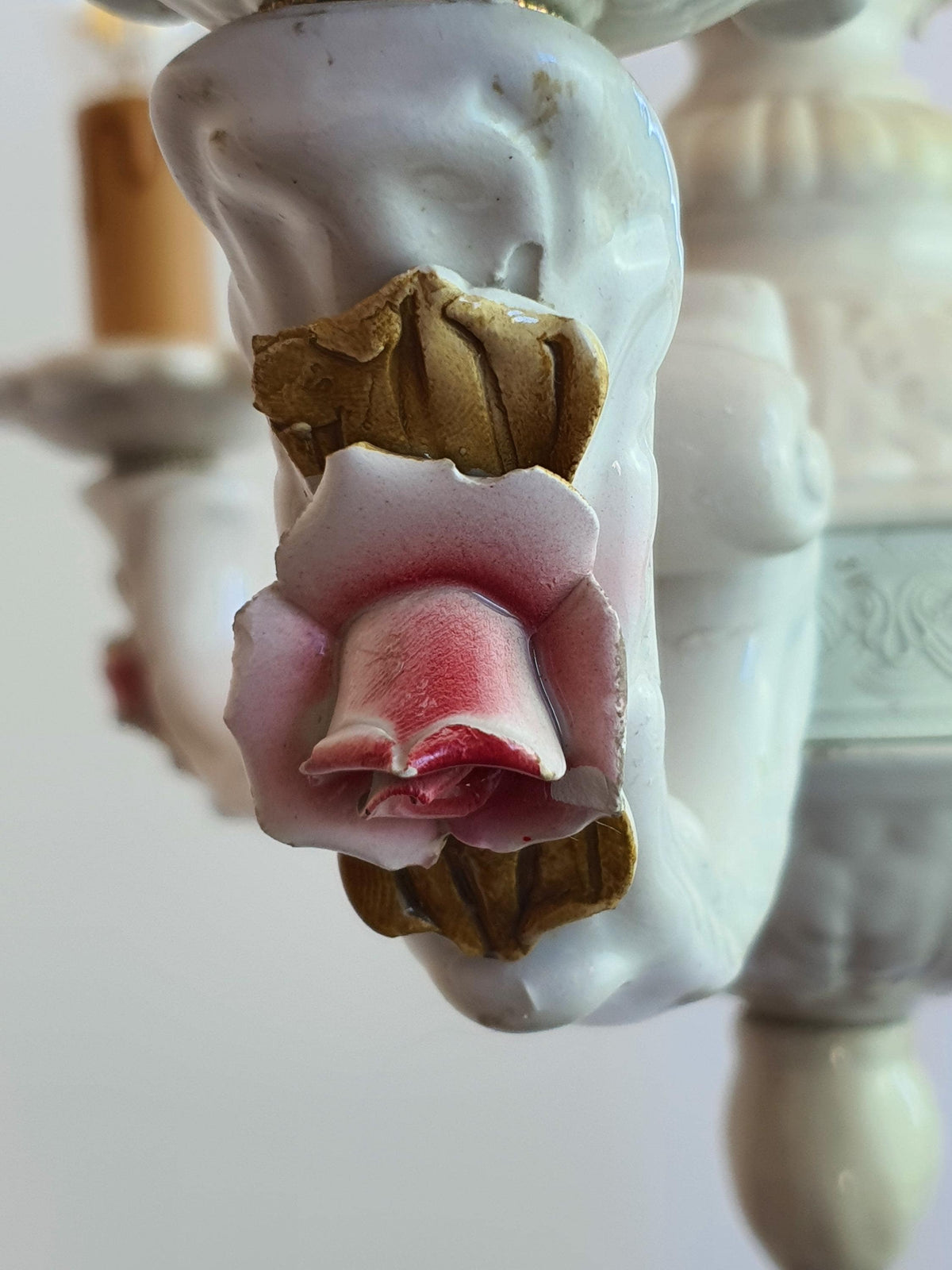 Detail of pink porcelain flowers on a vintage Italian chandelier

