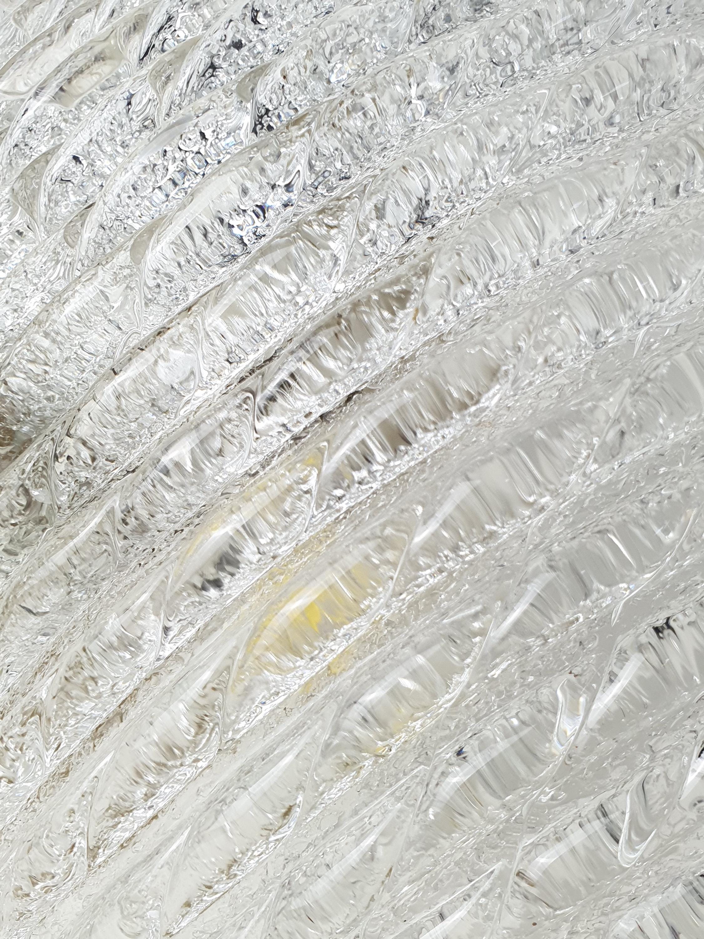 Close-up of thick ribbed iced glass texture on vintage Murano shell flush mount, deep ribbing light reflections