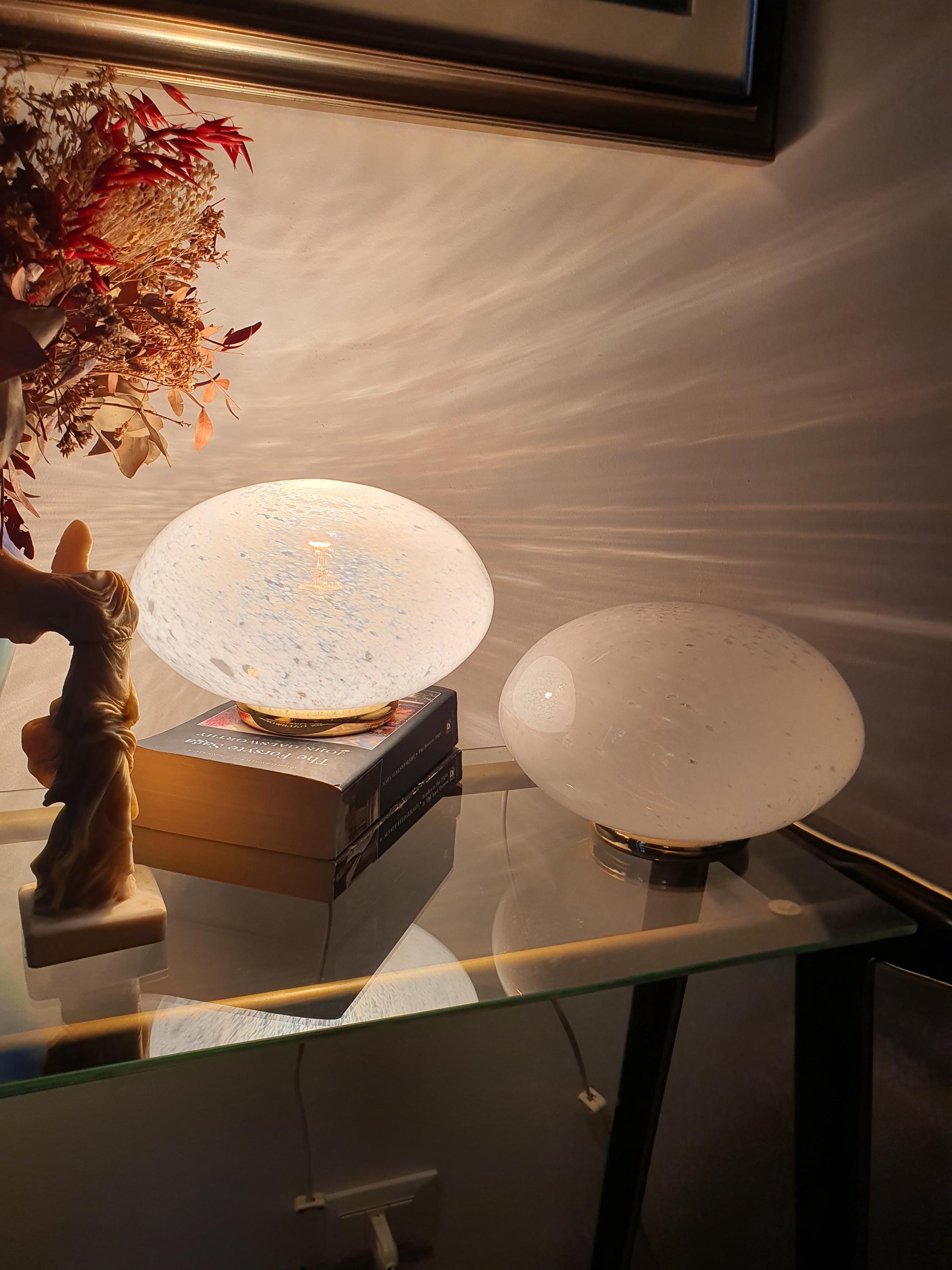 Pair of Vetri di Murano globe table lamps unlit, showing white spotted clear glass texture and brass bases