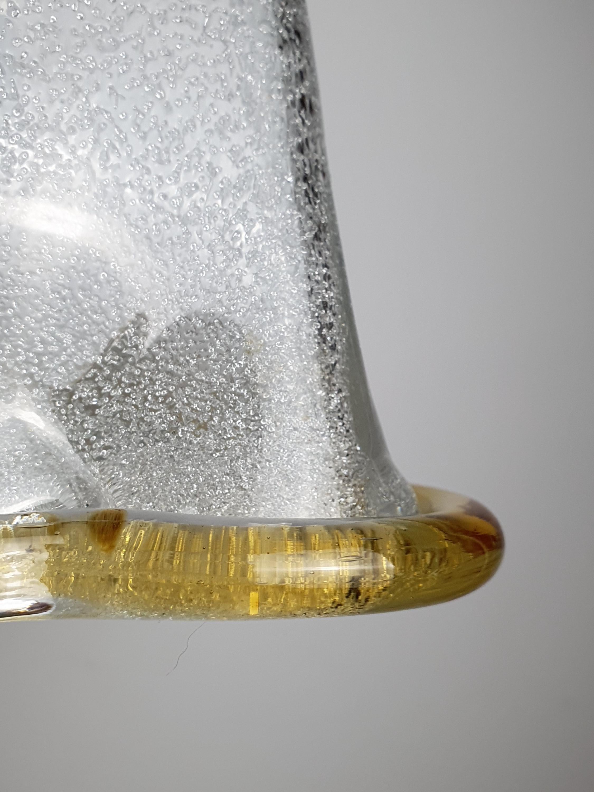Vintage Murano graniglia bell tulip pendant lit, warm crystalline glow through icy glass interior, yellow rim accent

