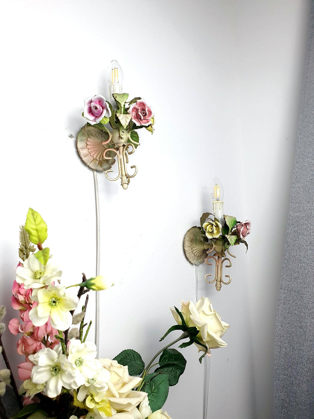 Pair of vintage 1950s Italian tole wall sconces — green painted metal with porcelain roses, front view