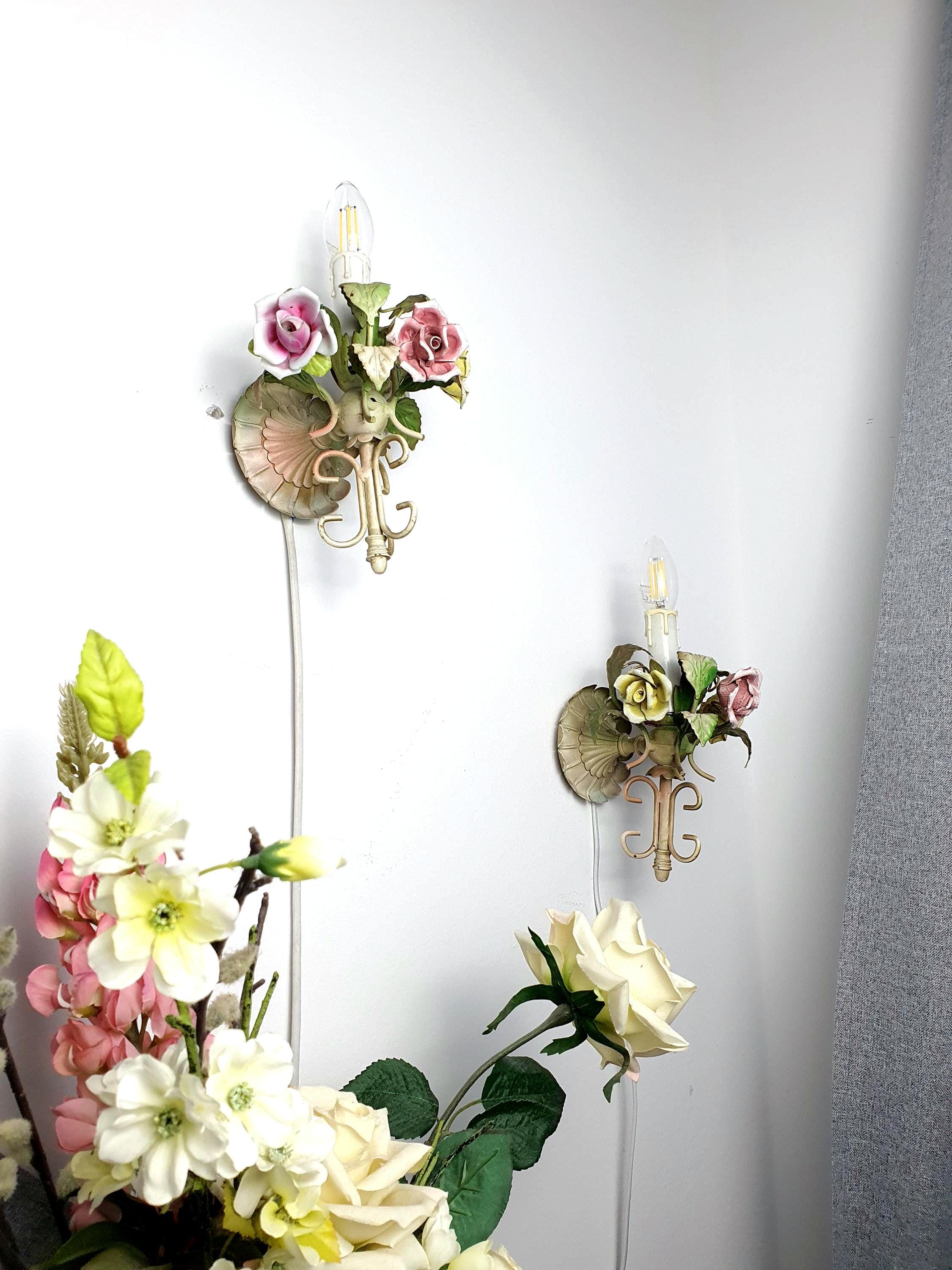 Pair of vintage 1950s Italian tole wall sconces — green painted metal with porcelain roses, front view